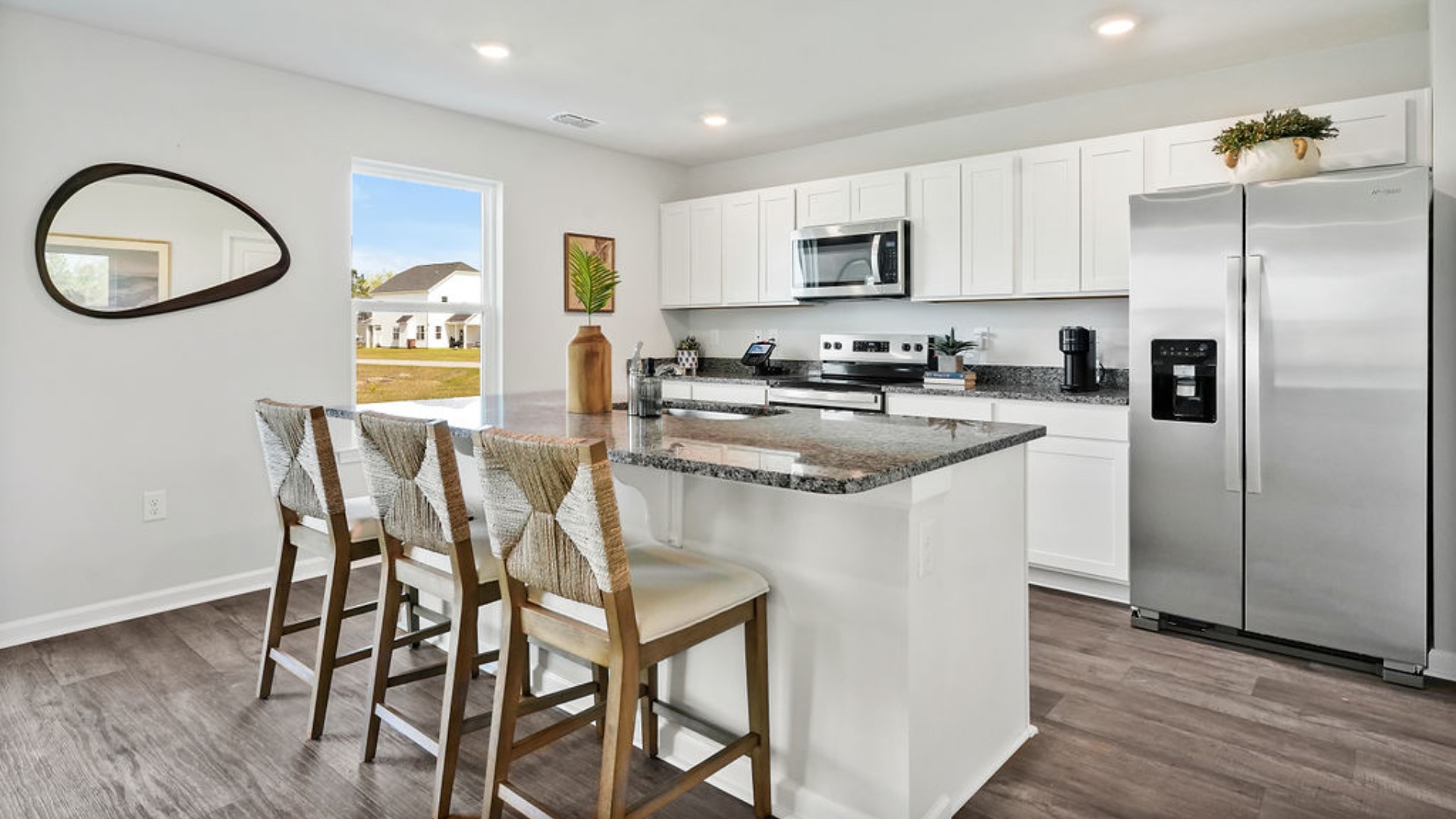 The kitchen features a large island and stainless-steel appliances,