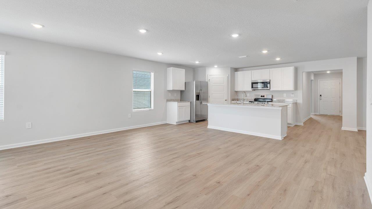 Seamlessly connected to the family and dining room, this kitchen is ideal for hosting gatherings and enjoying quality time with loved ones. The living area has back door access to a covered porch, further enhancing the relaxing ambiance.Seamlessly connected to the family and dining room, this kitchen is ideal for hosting gatherings and enjoying quality time with loved ones. The living area has back door access to a covered porch, further enhancing the relaxing ambiance.