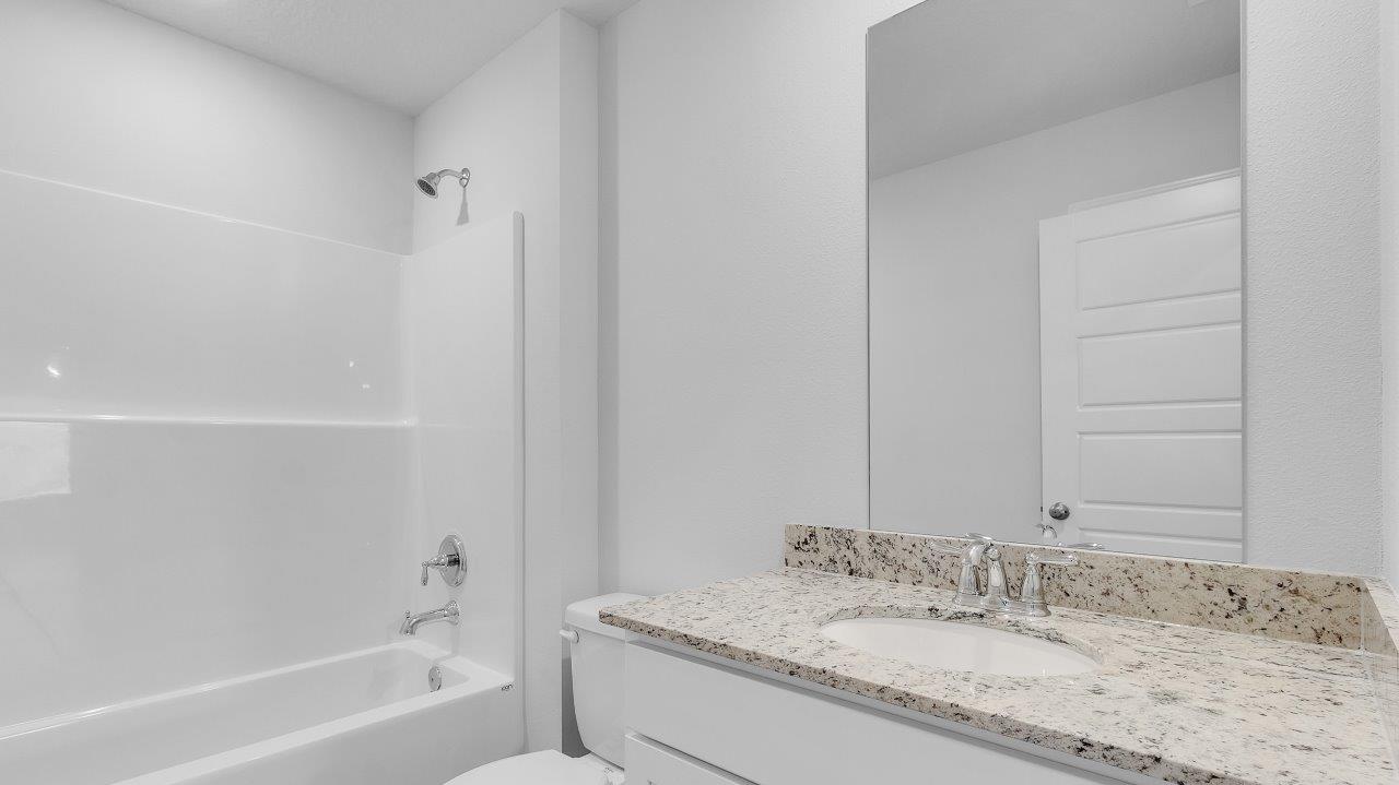 To the opposite side of the home are two bedrooms, a full bathroom with a linen closet and the laundry room. Y