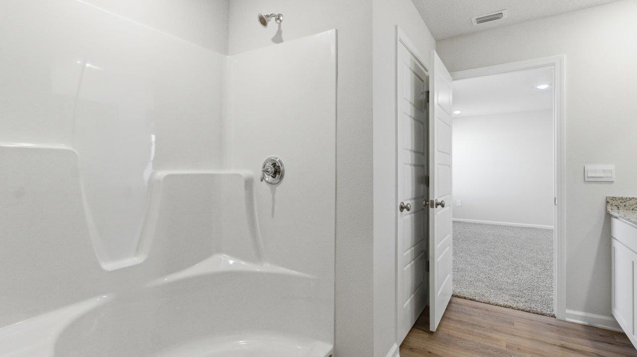 To the opposite side of the home are two bedrooms, a full bathroom with a linen closet and the laundry room. Y