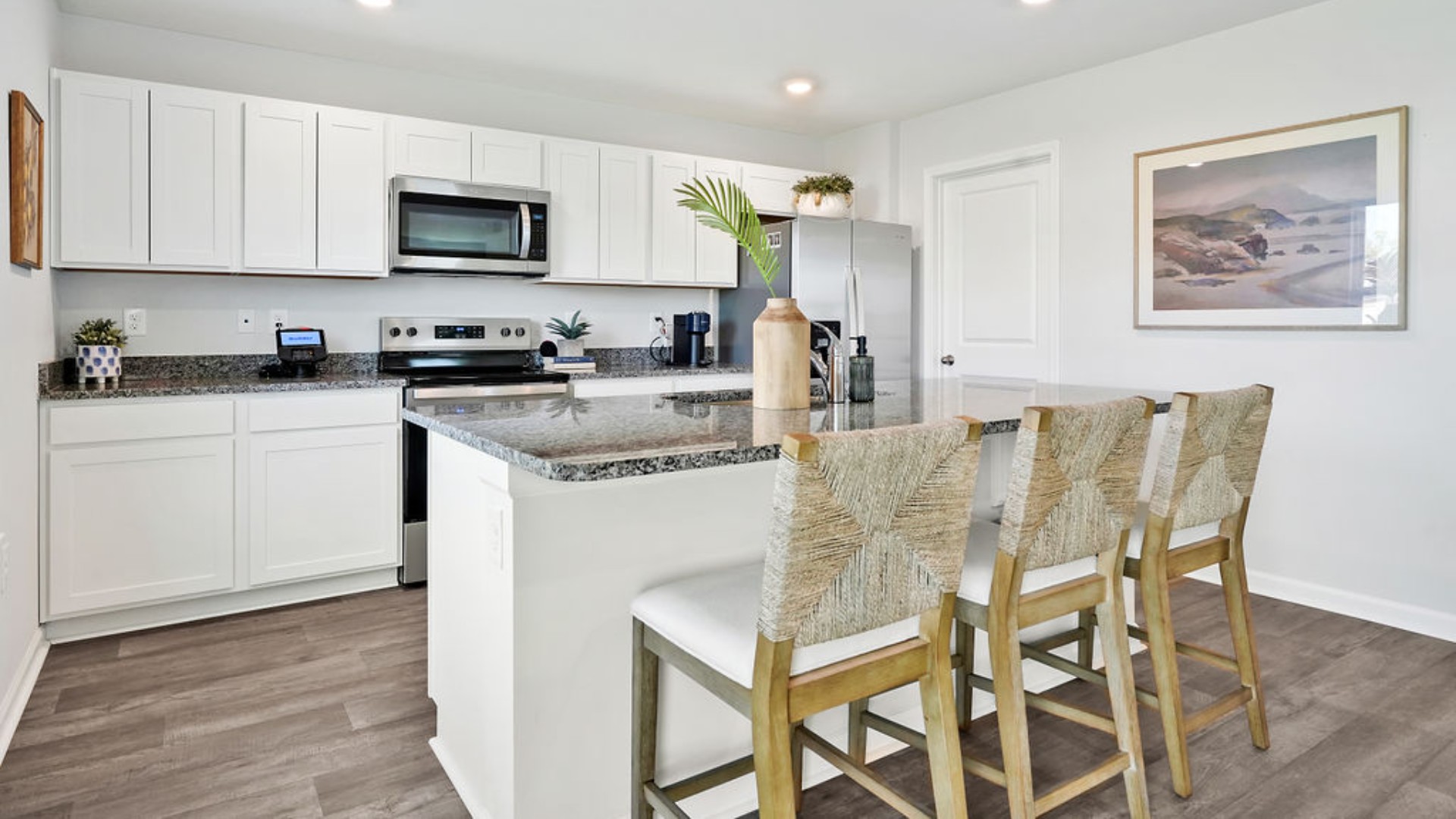 The kitchen features a large island and stainless steel appliances, which are sure to both turn heads and make meal prep easy. You’ll never be too far from the action with the living and dining area right there.