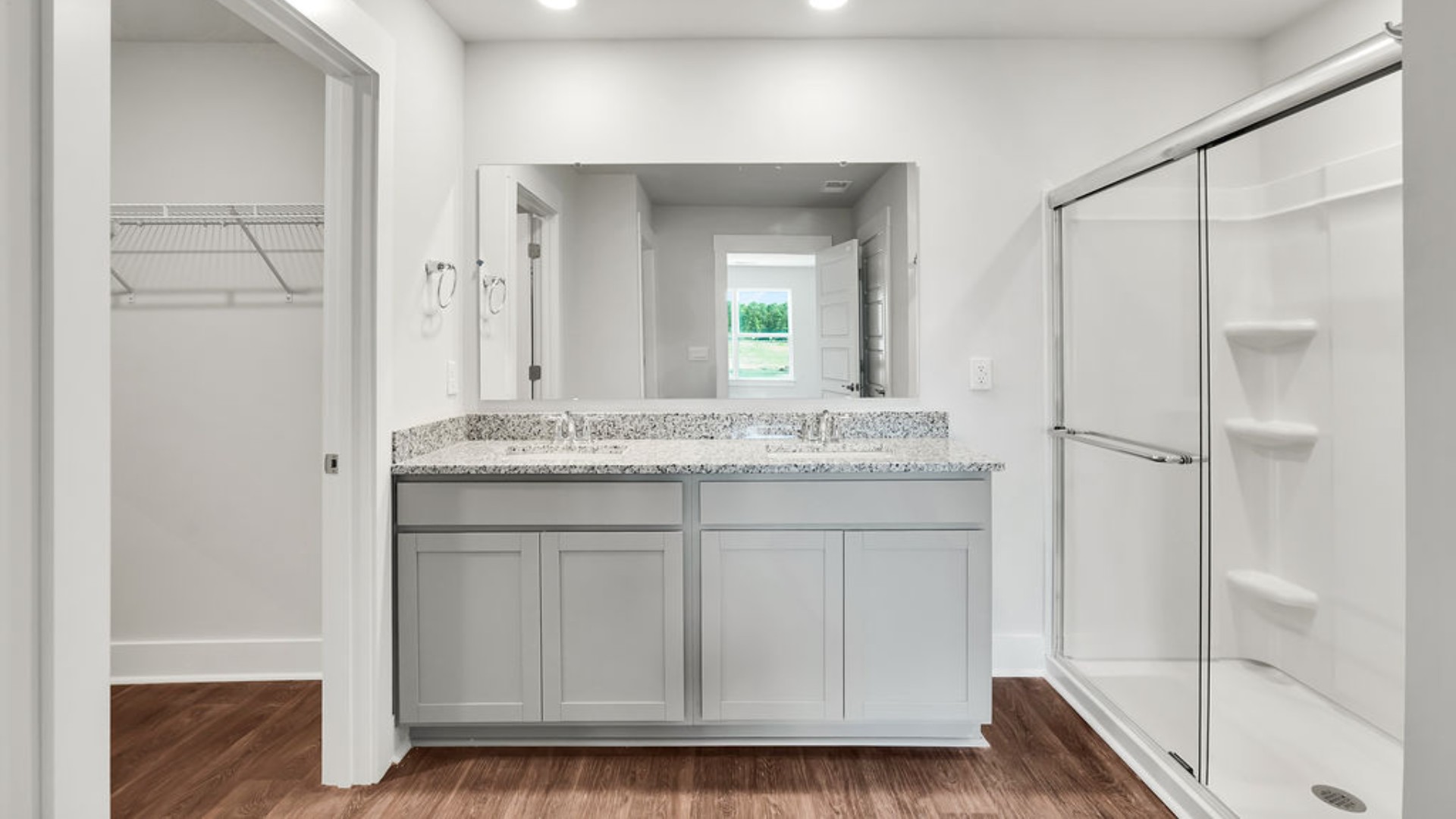 Featuring a first-floor primary bedroom with generous bath and walk-in closet.