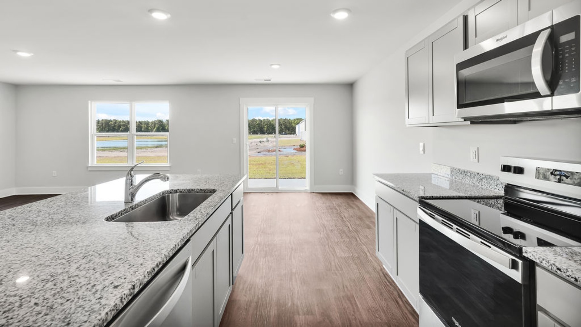 The kitchen features granite countertops, stainless steel appliances and boasts a large island with room for seating and opens to the casual dining area and spacious family room. There is also a wonderful flex space on the main level that could be a dedicated home office or a formal dining room.