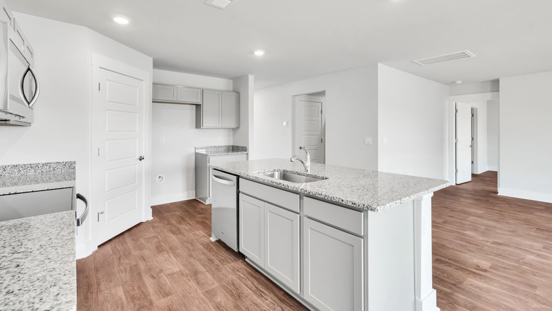 The kitchen features granite countertops, stainless steel appliances and boasts a large island with room for seating and opens to the casual dining area and spacious family room. There is also a wonderful flex space on the main level that could be a dedicated home office or a formal dining room.