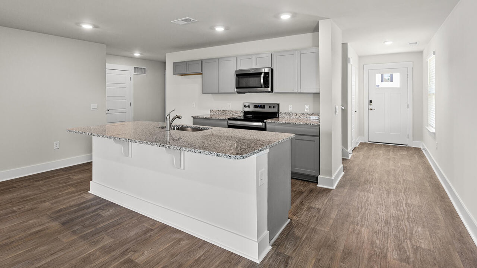 The kitchen features beautiful cabinets, granite countertops, and stainless steel appliances, which are sure to both turn heads and make meal prep easy. You’ll never be too far from the action with the living and dining area right there.