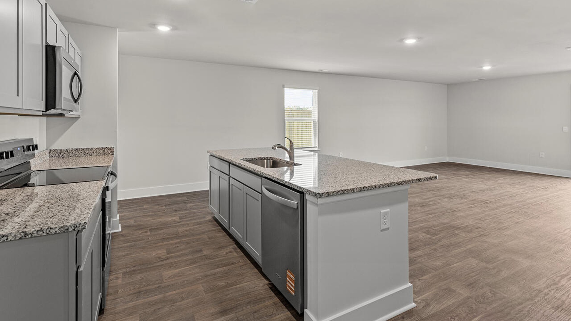 The kitchen features beautiful cabinets, granite countertops, and stainless steel appliances, which are sure to both turn heads and make meal prep easy. You’ll never be too far from the action with the living and dining area right there.