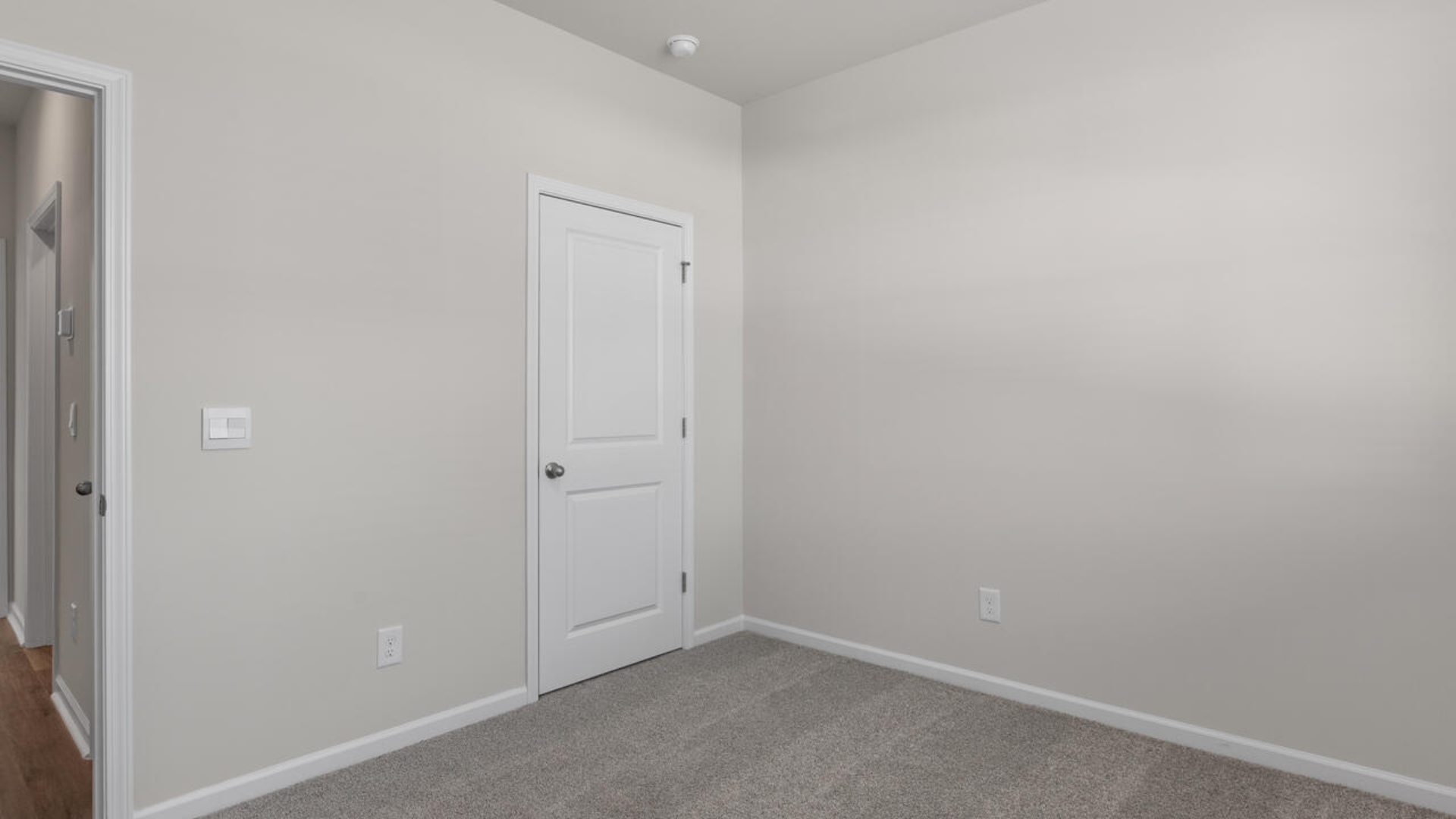 Two additional bedrooms and a full hall bathroom provide great flexibility for guests, office space, or a hobby room. A covered porch extends the living space outdoors