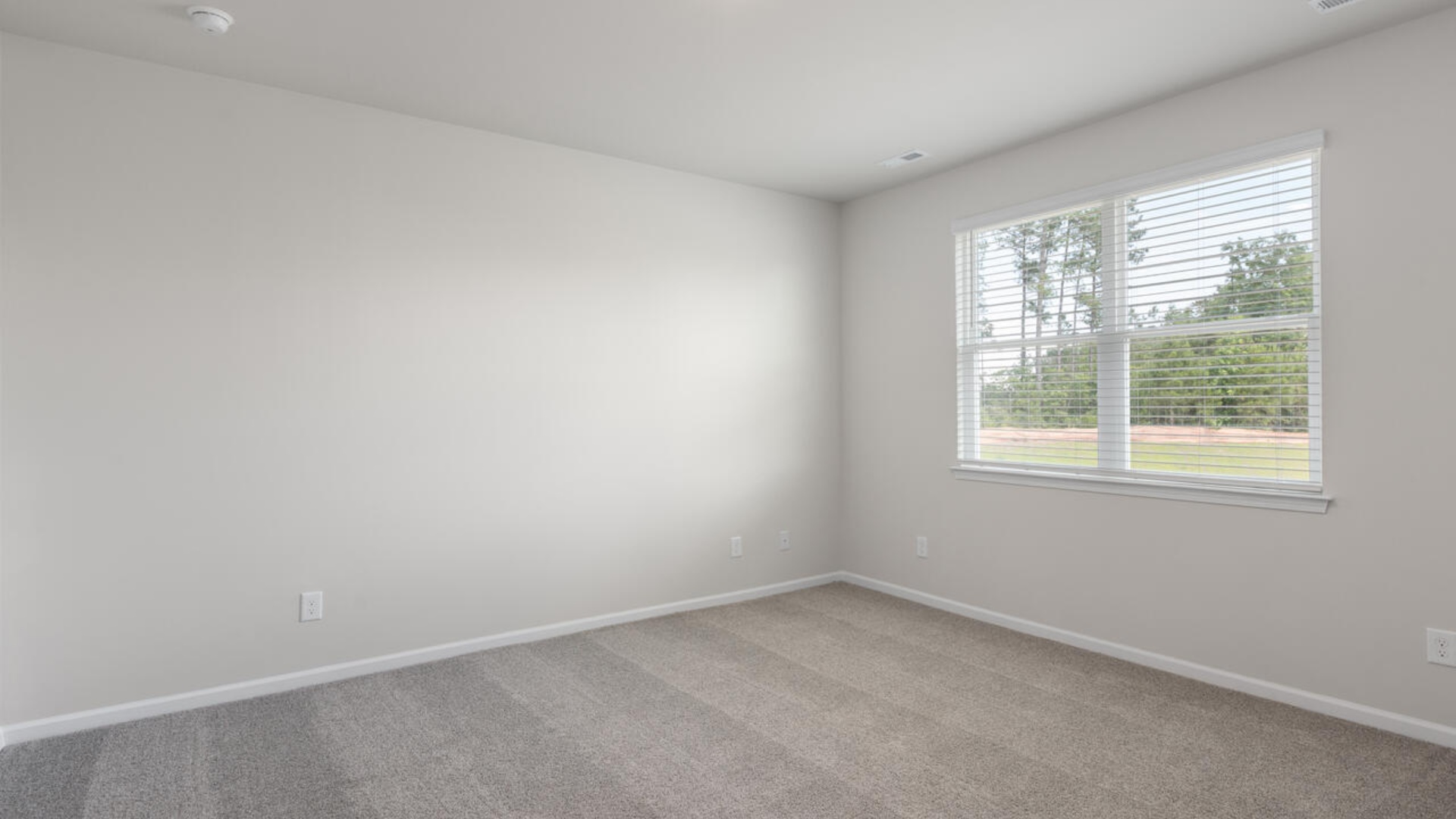 The primary suite offers a spacious walk-in closet and a private bath with dual vanity, walk-in shower, and linen storage.