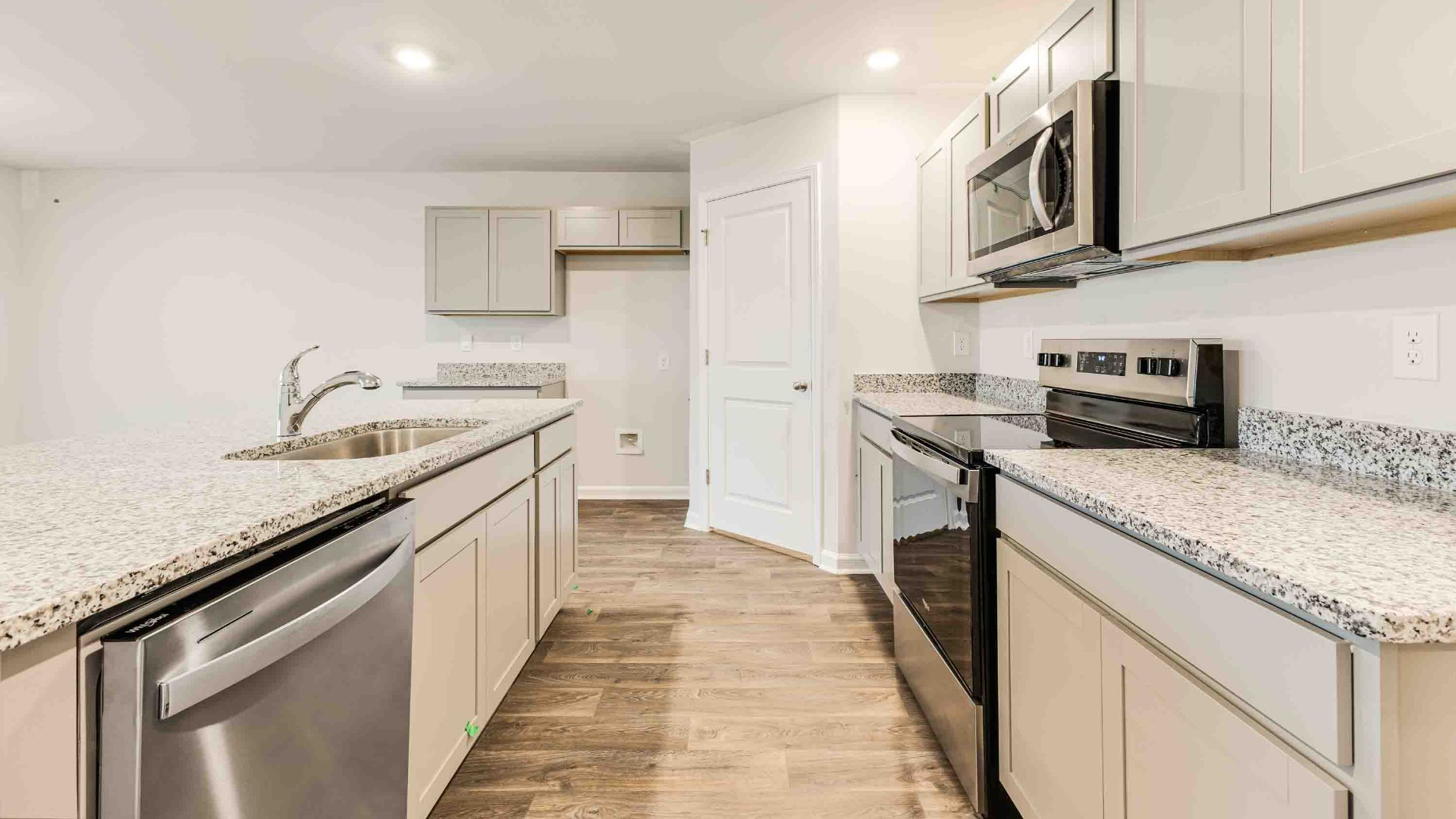 he kitchen features beautiful cabinets, granite countertops, and stainless-steel appliances, which are sure to both turn heads and make meal prep easy.