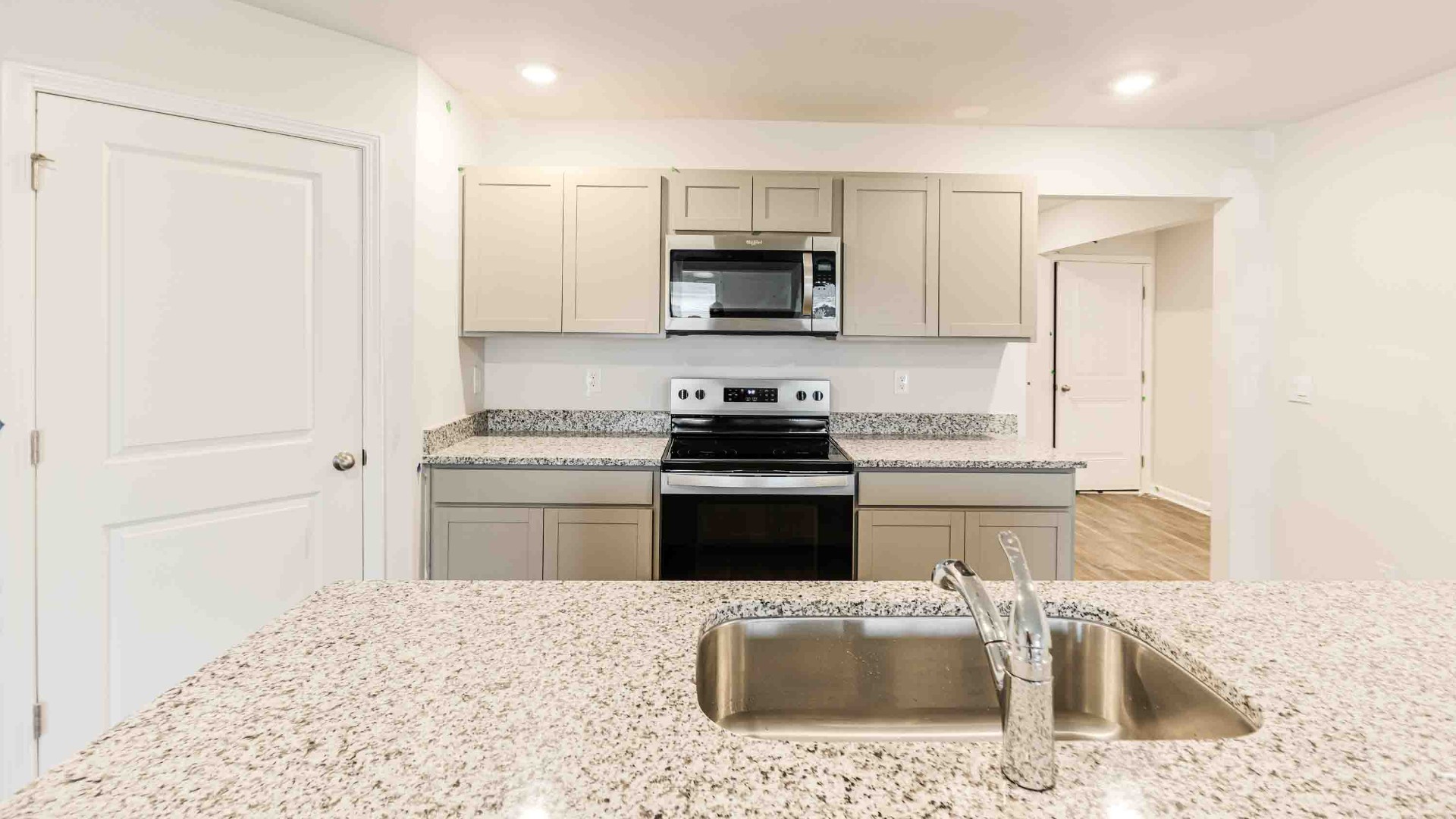 he kitchen features beautiful cabinets, granite countertops, and stainless-steel appliances, which are sure to both turn heads and make meal prep easy.