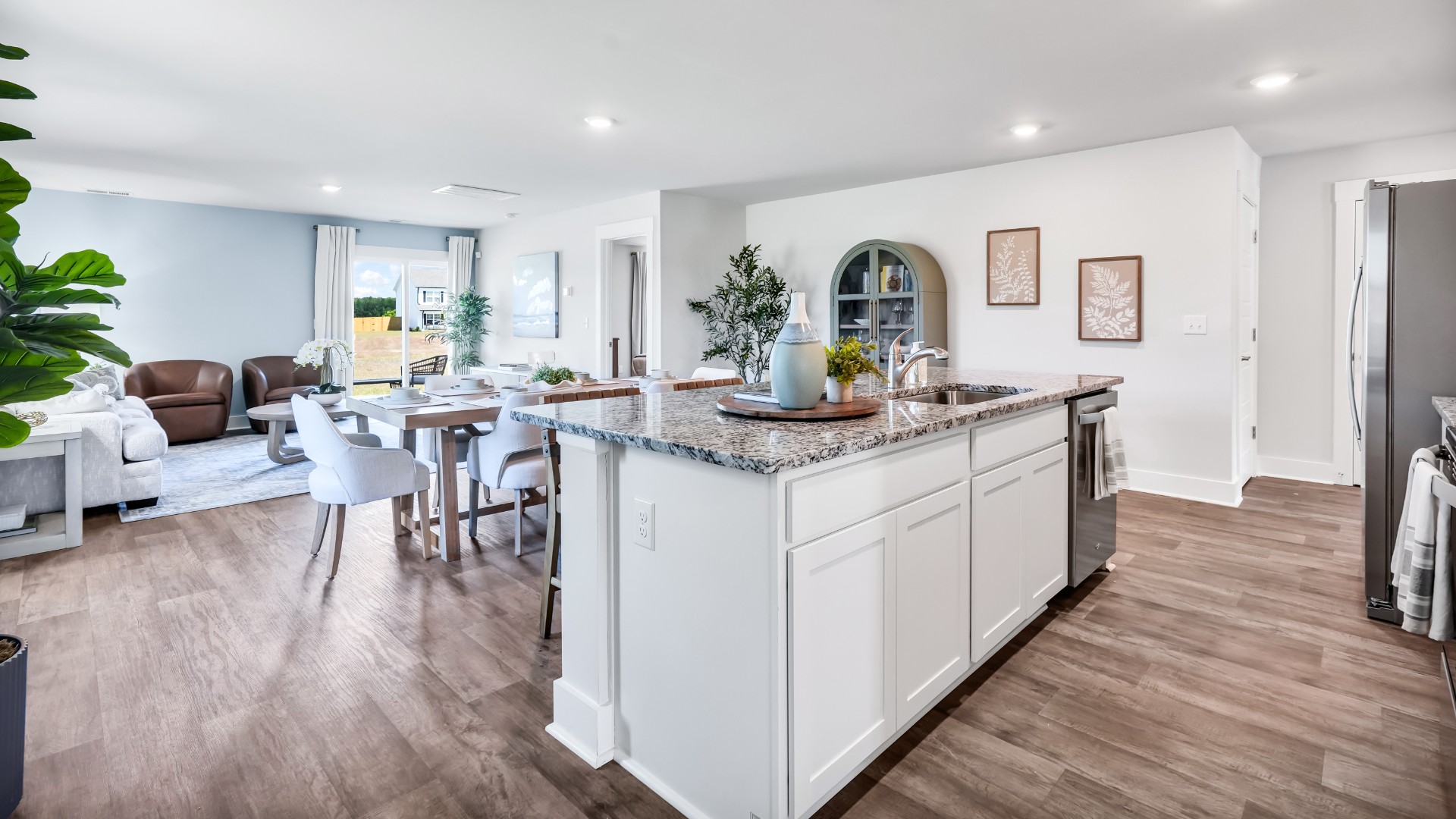 The kitchen features beautiful cabinets, granite countertops, and stainless-steel appliances, which are sure to both turn heads and make meal prep easy. You’ll never be too far from the action with the living and dining area right there.