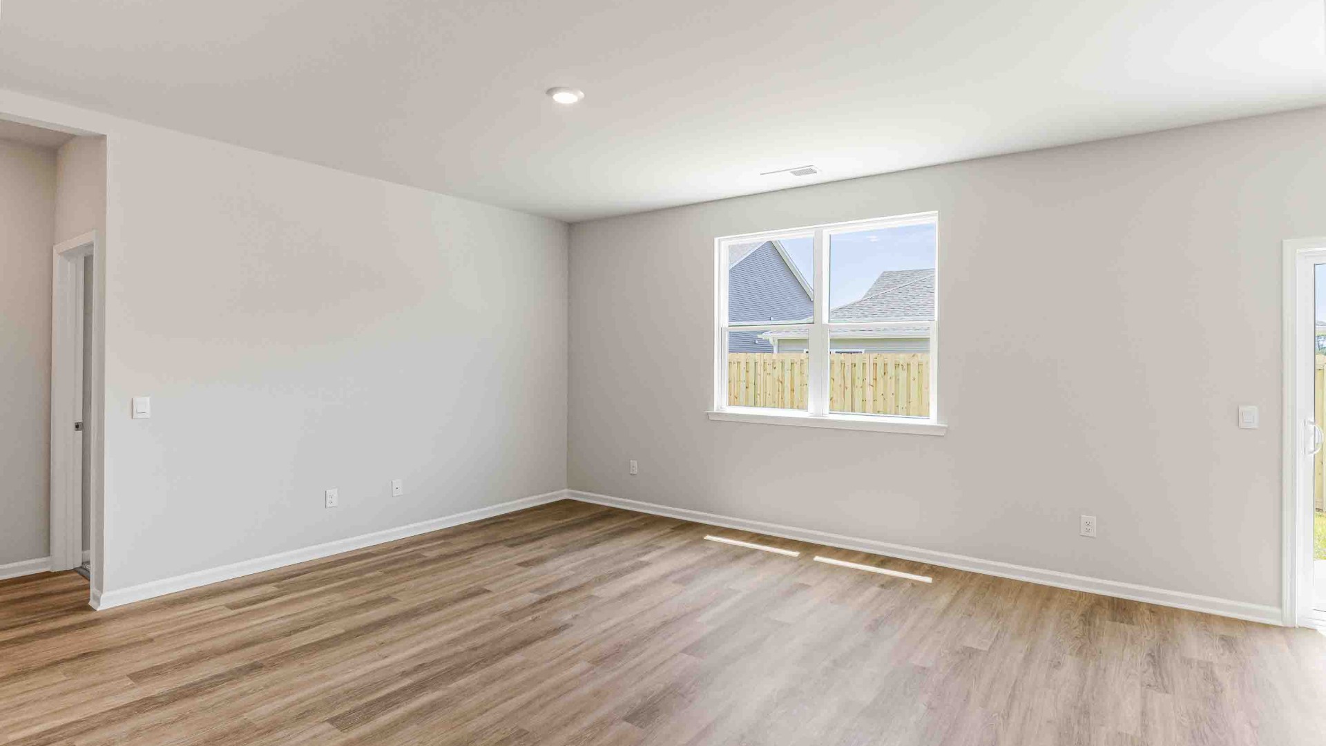 The open-concept kitchen features granite countertops and stainless-steel appliances. The large island is great for gatherings. The kitchen seamlessly connects to the dining and living areas, creating a great space for entertainment.