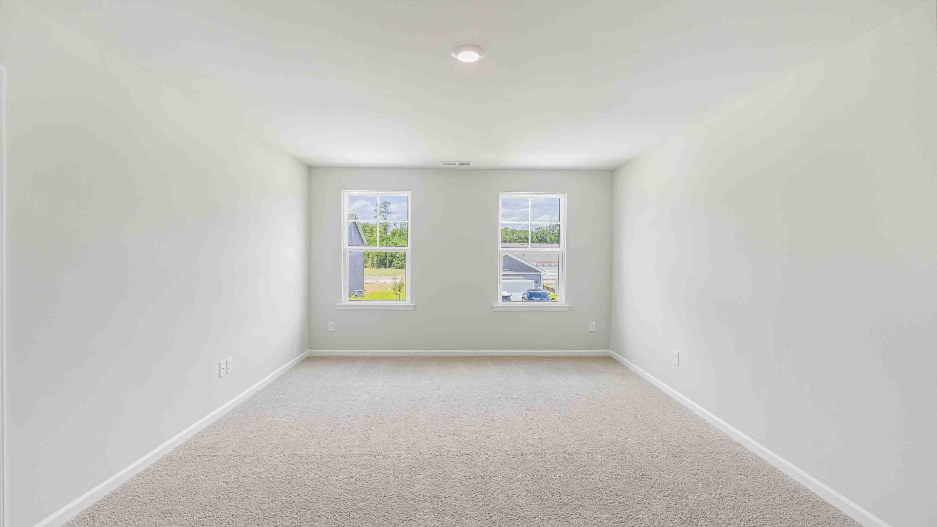 The upstairs has an additional living space, a laundry room, and a primary bedroom.