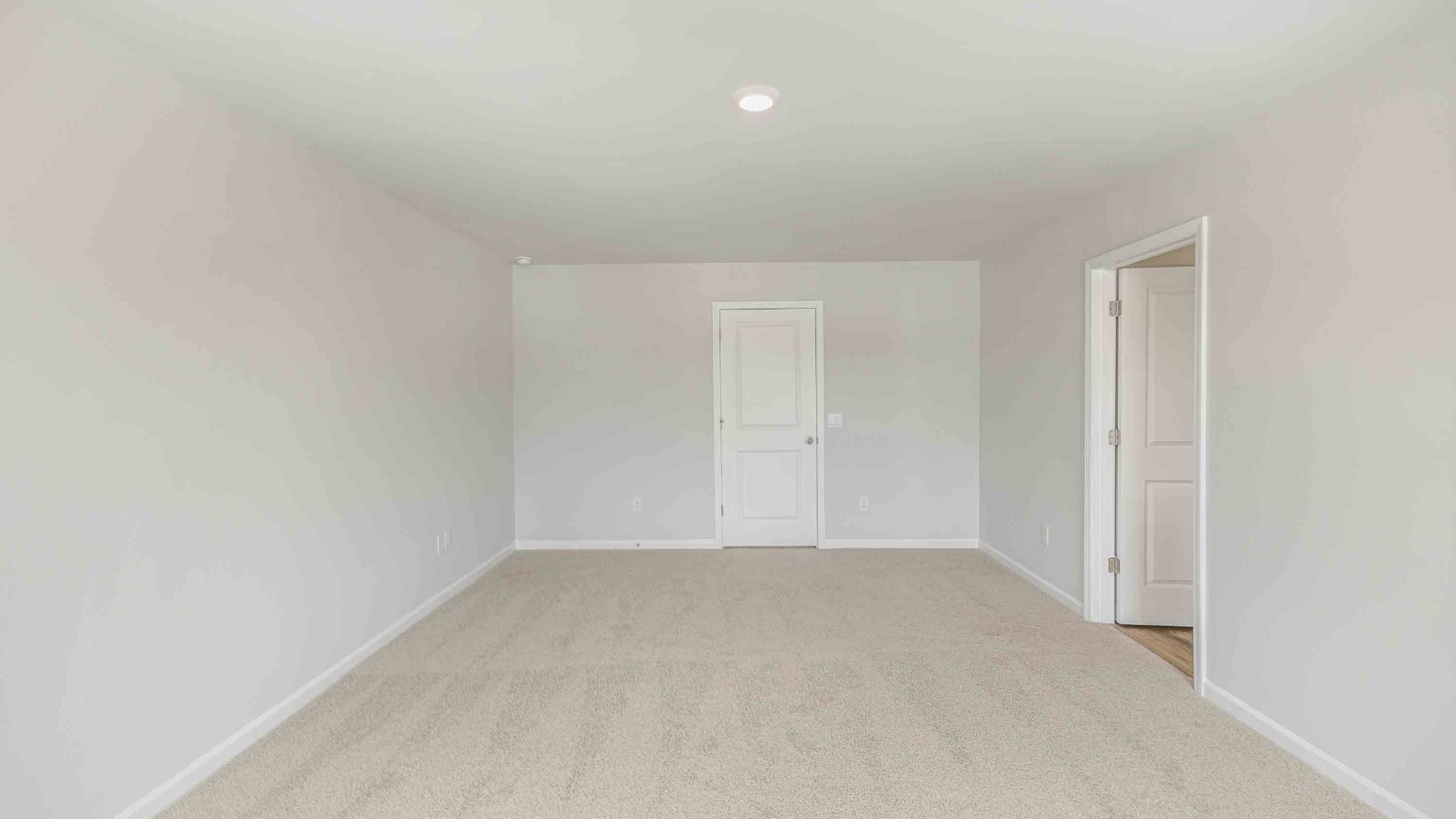 The upstairs has an additional living space, a laundry room, and a primary bedroom.