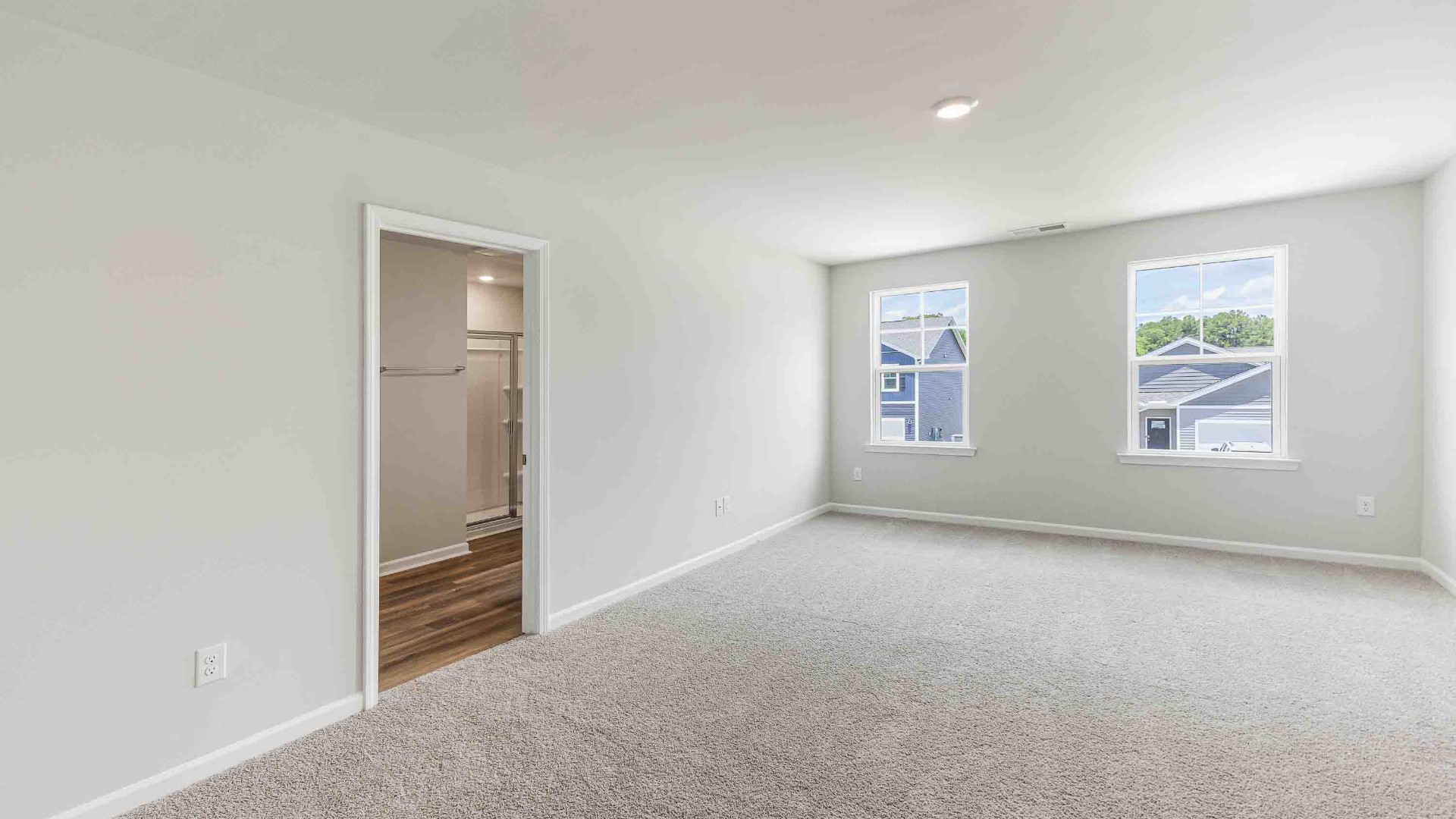 The upstairs has an additional living space, a laundry room, and a primary bedroom.
