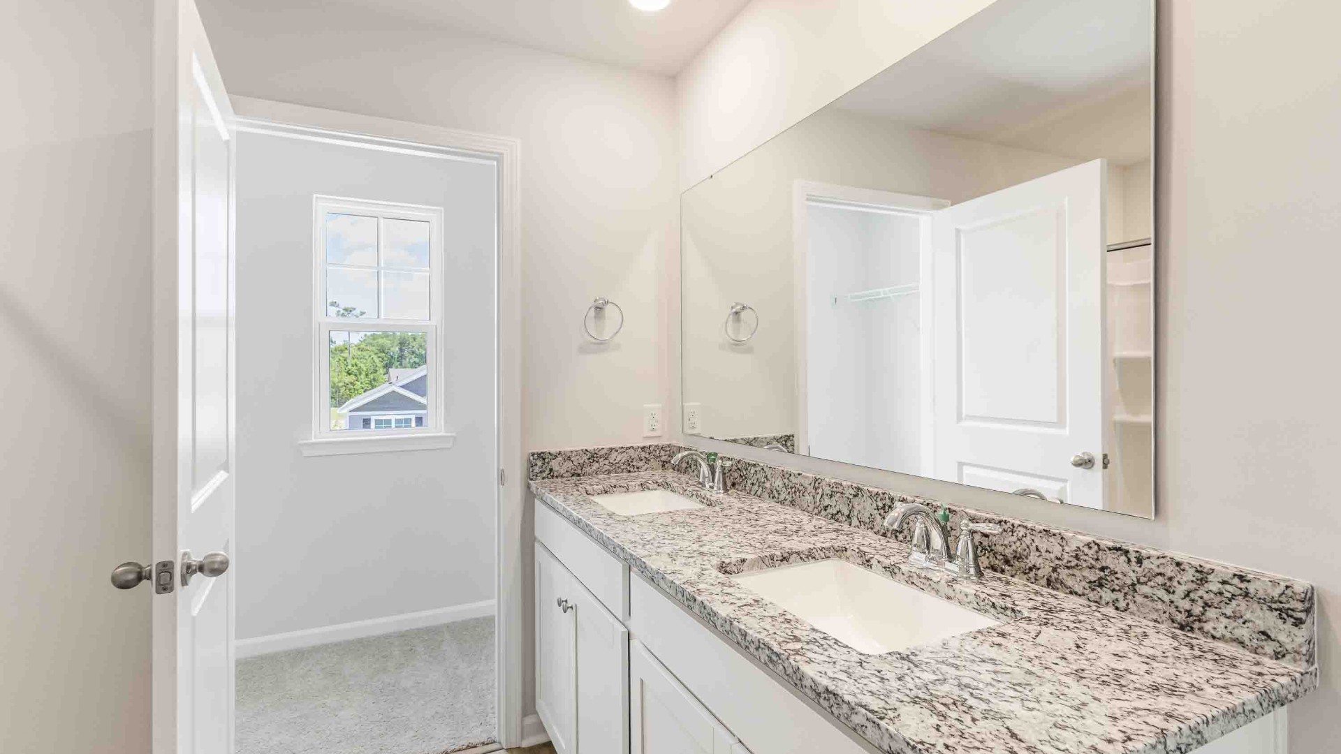 The upstairs has an additional living space, a laundry room, and a primary bedroom.