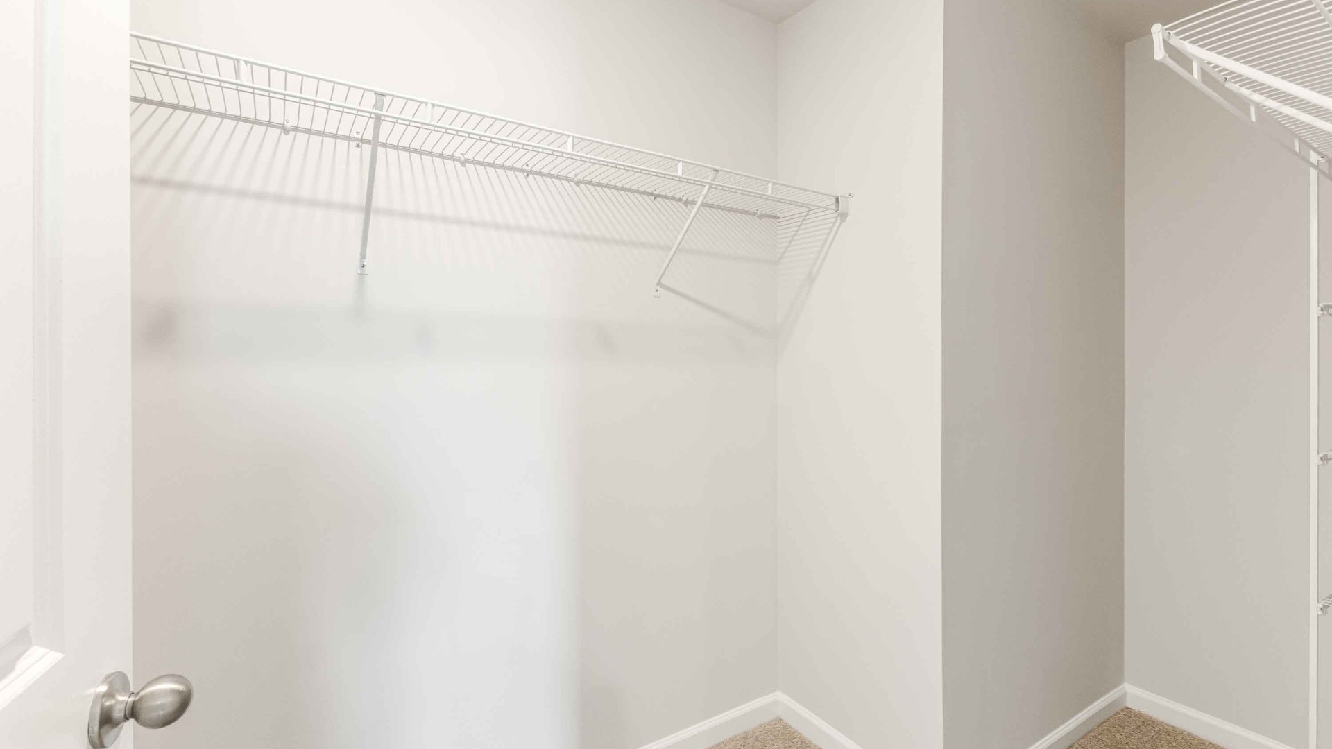 The upstairs has an additional living space, a laundry room, and a primary bedroom.