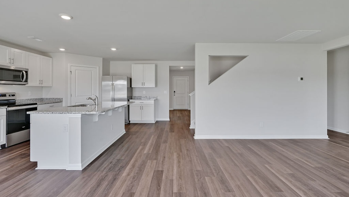 New Homes in Jacksonville NC. Vineyard Trail. The Hayden Floorplan offers 2,511 square feet with 5 bedrooms, 3 full bathrooms, and a 2-car garage. The upstairs has an additional living space, a laundry room, and a Primary Bedroom. Downstairs, a flex room can be used as an office or sitting area, while the open-concept kitchen features granite countertops and stainless steel appliances. The kitchen seamlessly connects to the dining and living areas, creating a great space for entertainment. If you're seeking a spacious home with modern features, the Hayden Floorplan is a top choice.