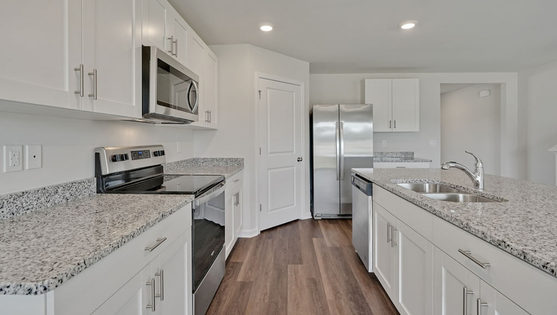 New Homes in Jacksonville NC. Vineyard Trail. The Hayden Floorplan offers 2,511 square feet with 5 bedrooms, 3 full bathrooms, and a 2-car garage. The upstairs has an additional living space, a laundry room, and a Primary Bedroom. Downstairs, a flex room can be used as an office or sitting area, while the open-concept kitchen features granite countertops and stainless steel appliances. The kitchen seamlessly connects to the dining and living areas, creating a great space for entertainment. If you're seeking a spacious home with modern features, the Hayden Floorplan is a top choice.