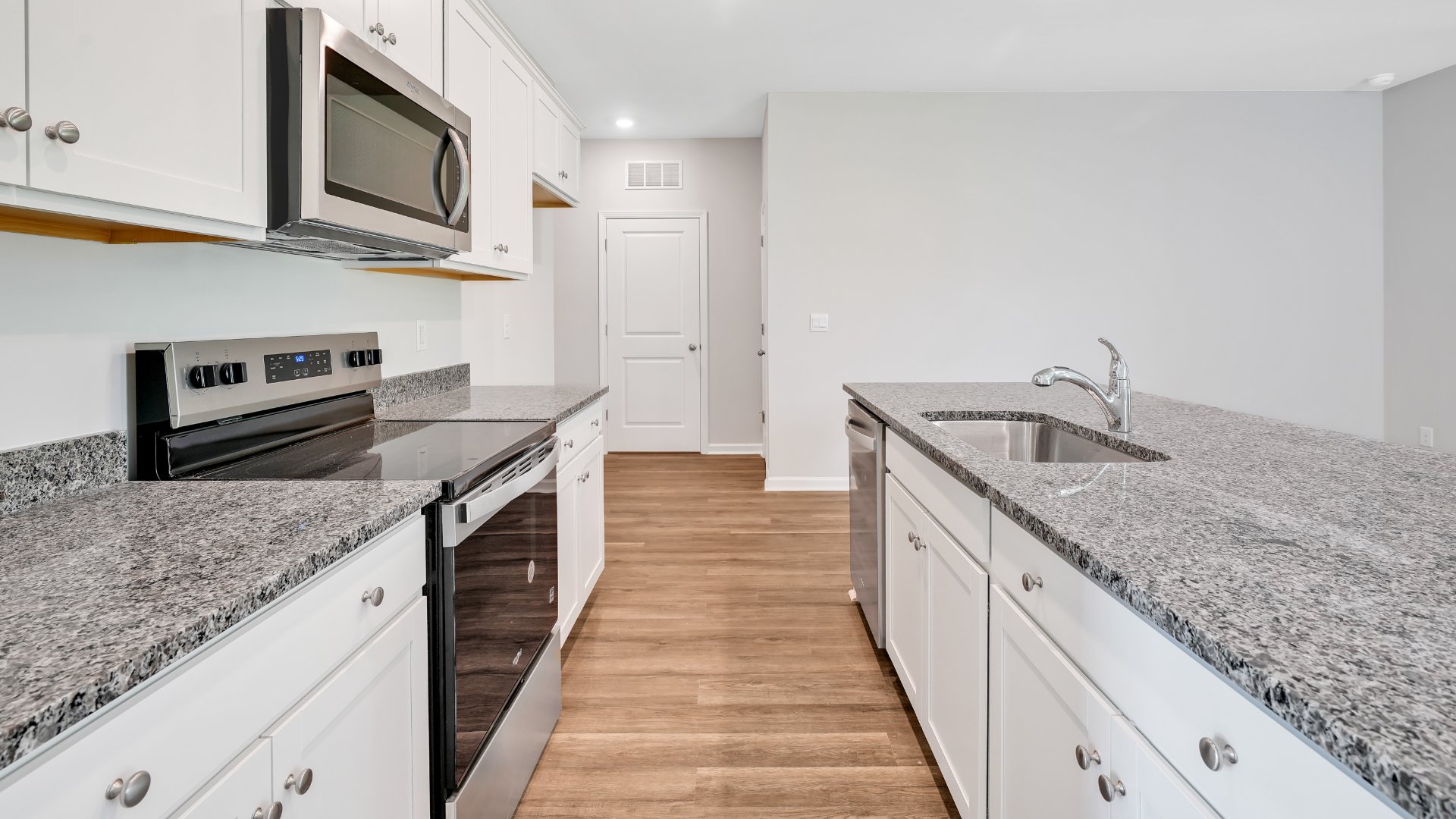 The kitchen features beautiful cabinets, granite countertops, and stainless steel appliances, which are sure to both turn heads and make meal prep easy.