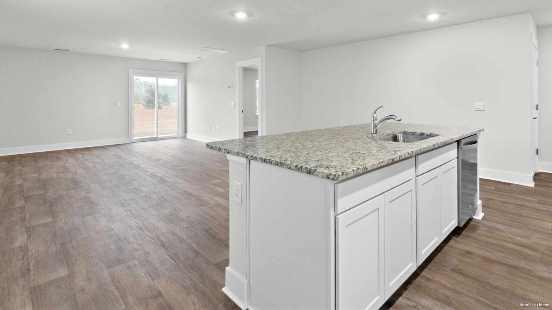 The kitchen features beautiful cabinets, granite countertops, and stainless-steel appliances, which are sure to both turn heads and make meal prep easy.