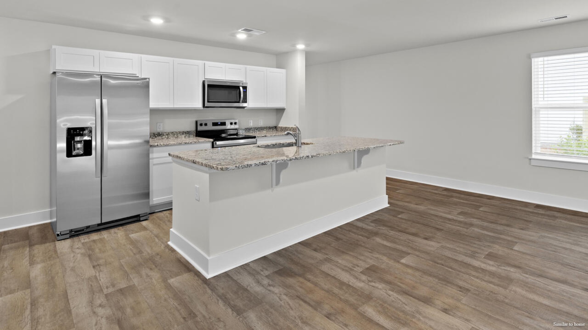 The kitchen features beautiful cabinets, granite countertops, and stainless-steel appliances, which are sure to both turn heads and make meal prep easy.