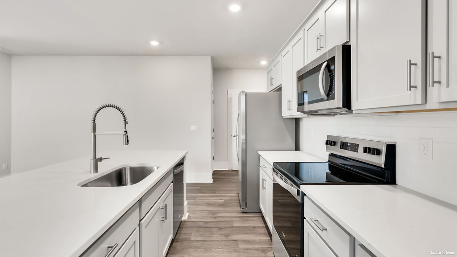The kitchen features beautiful cabinets, granite countertops, and stainless steel appliances, which are sure to both turn heads and make meal prep easy.