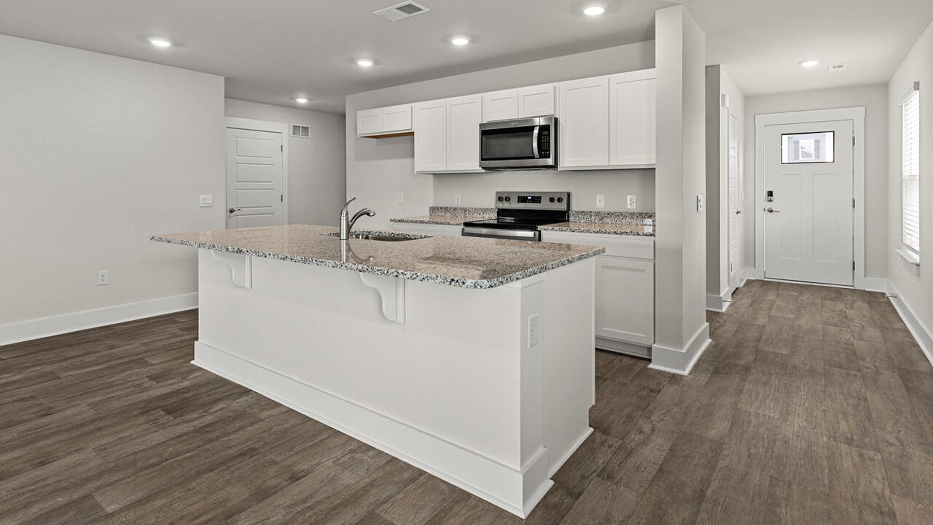 The kitchen features beautiful cabinets, granite countertops, and stainless-steel appliances, which are sure to both turn heads and make meal prep easy.