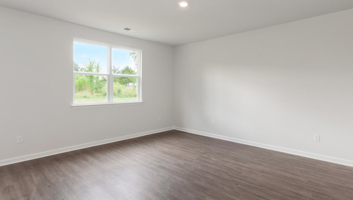 . Two additional bedrooms at the front of the home share a full bath. A conveniently located laundry room near the kitchen adds to the home’s smart and practical design.