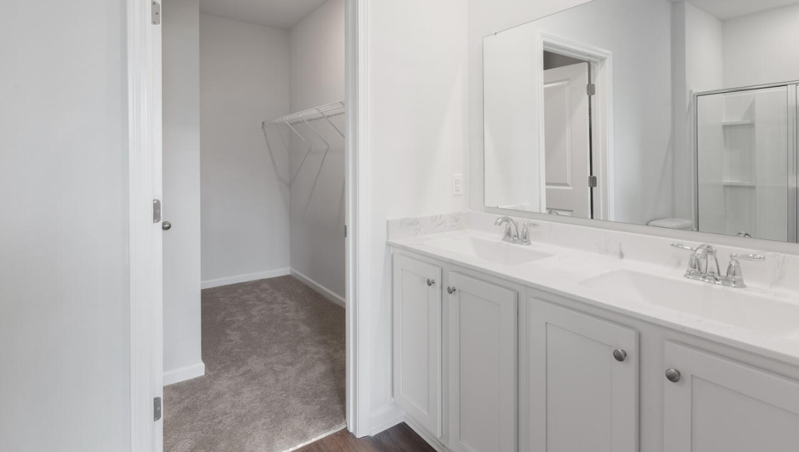 . Two additional bedrooms at the front of the home share a full bath. A conveniently located laundry room near the kitchen adds to the home’s smart and practical design.