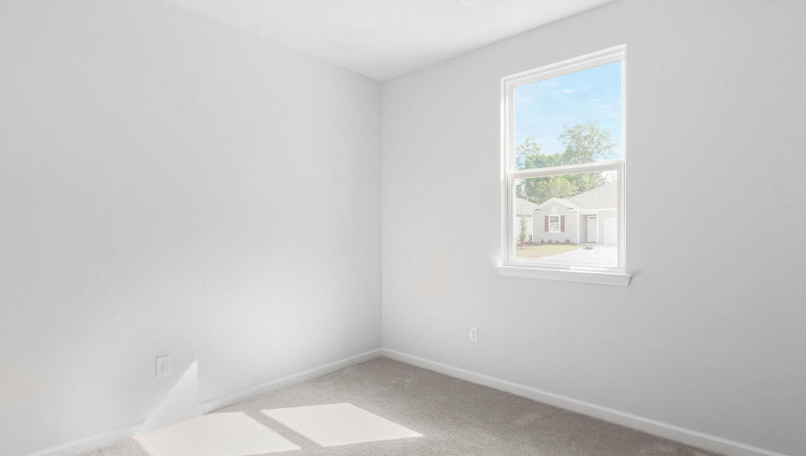 . Two additional bedrooms at the front of the home share a full bath. A conveniently located laundry room near the kitchen adds to the home’s smart and practical design.
