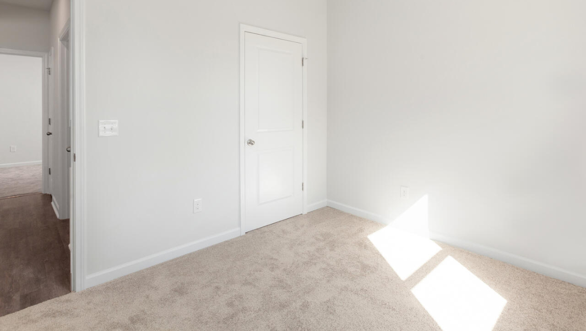 . Two additional bedrooms at the front of the home share a full bath. A conveniently located laundry room near the kitchen adds to the home’s smart and practical design.