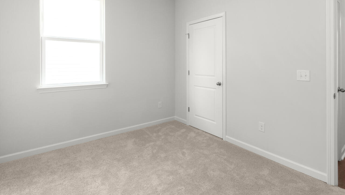 . Two additional bedrooms at the front of the home share a full bath. A conveniently located laundry room near the kitchen adds to the home’s smart and practical design.