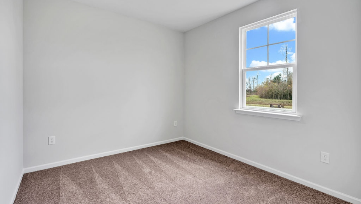 At the front are two guest bedrooms and a full bathroom, perfect for visitors or a home office.