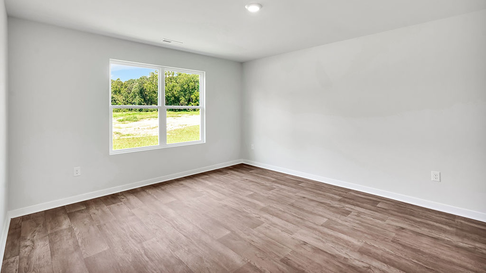 At the back, the Primary Suite provides privacy with a large walk-in closet and walk-in shower. This floor plan combines comfort and convenience, making it a great choice for those seeking an open layout.