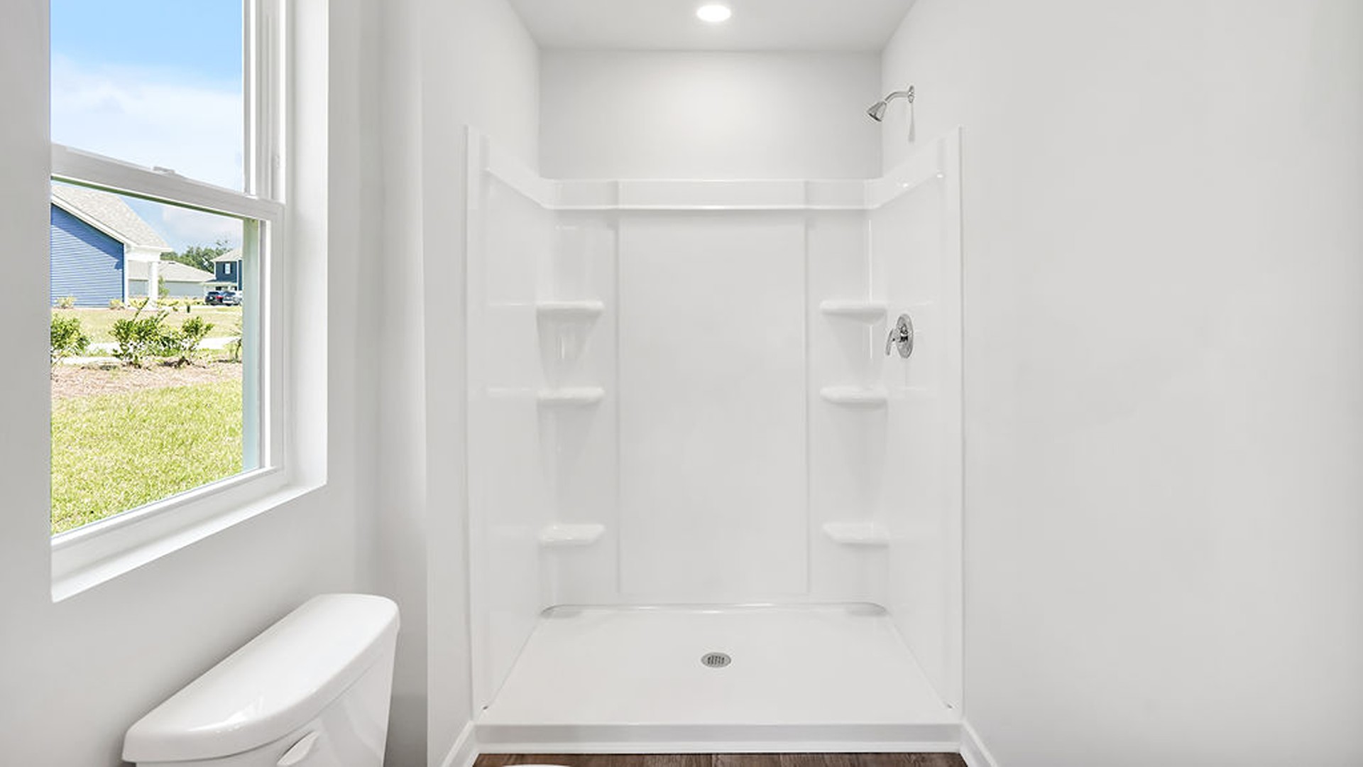 At the back, the Primary Suite provides privacy with a large walk-in closet and walk-in shower. This floor plan combines comfort and convenience, making it a great choice for those seeking an open layout.