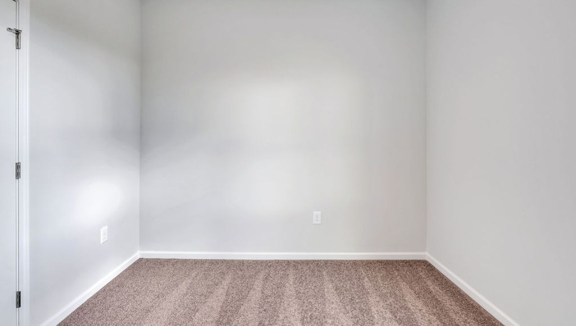 At the front are two guest bedrooms and a full bathroom, perfect for visitors or a home office.