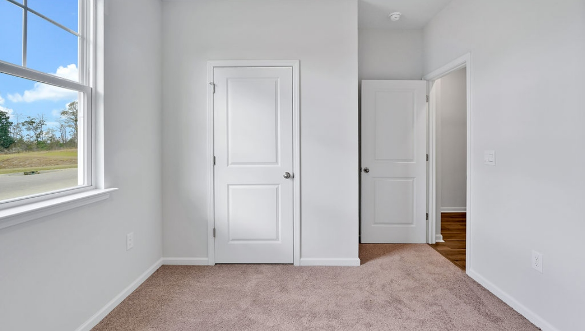 At the front are two guest bedrooms and a full bathroom, perfect for visitors or a home office.