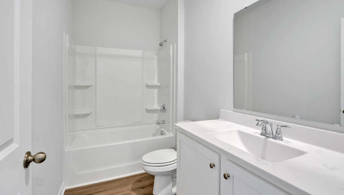 At the front are two guest bedrooms and a full bathroom, perfect for visitors or a home office.