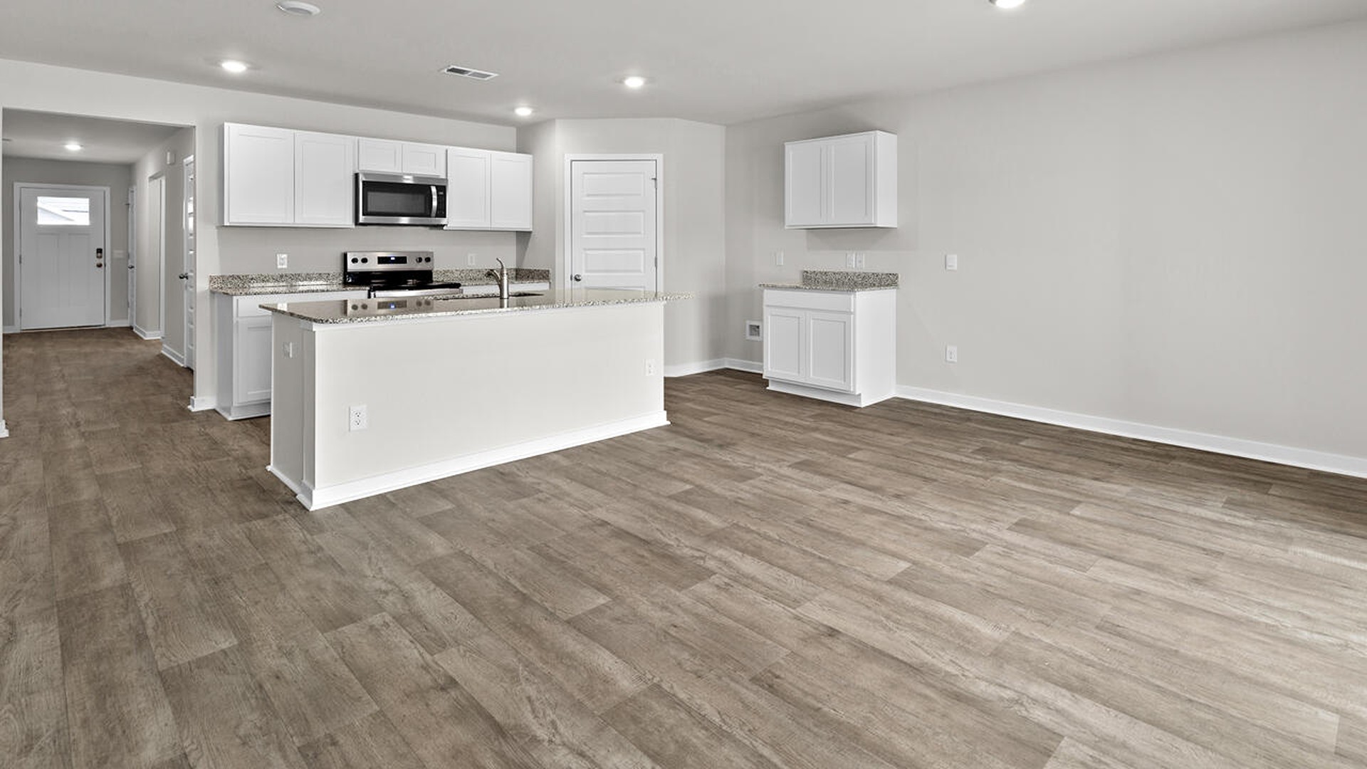 The kitchen features beautiful cabinets, granite countertops, and stainless-steel appliances, which are sure to both turn heads and make meal prep easy.