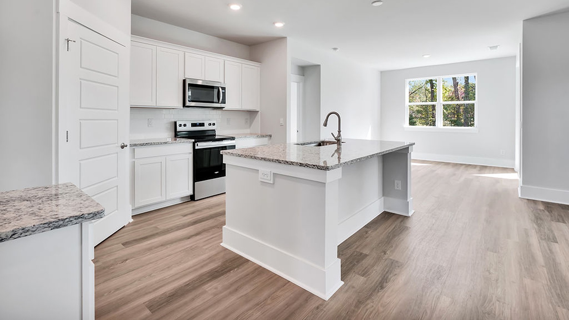 The Bradford is a versatile plan with an open concept kitchen, living, and dining area! The kitchen comes finished with beautiful granite countertops, stainless steel appliances, single-bowl sink and tile backsplash