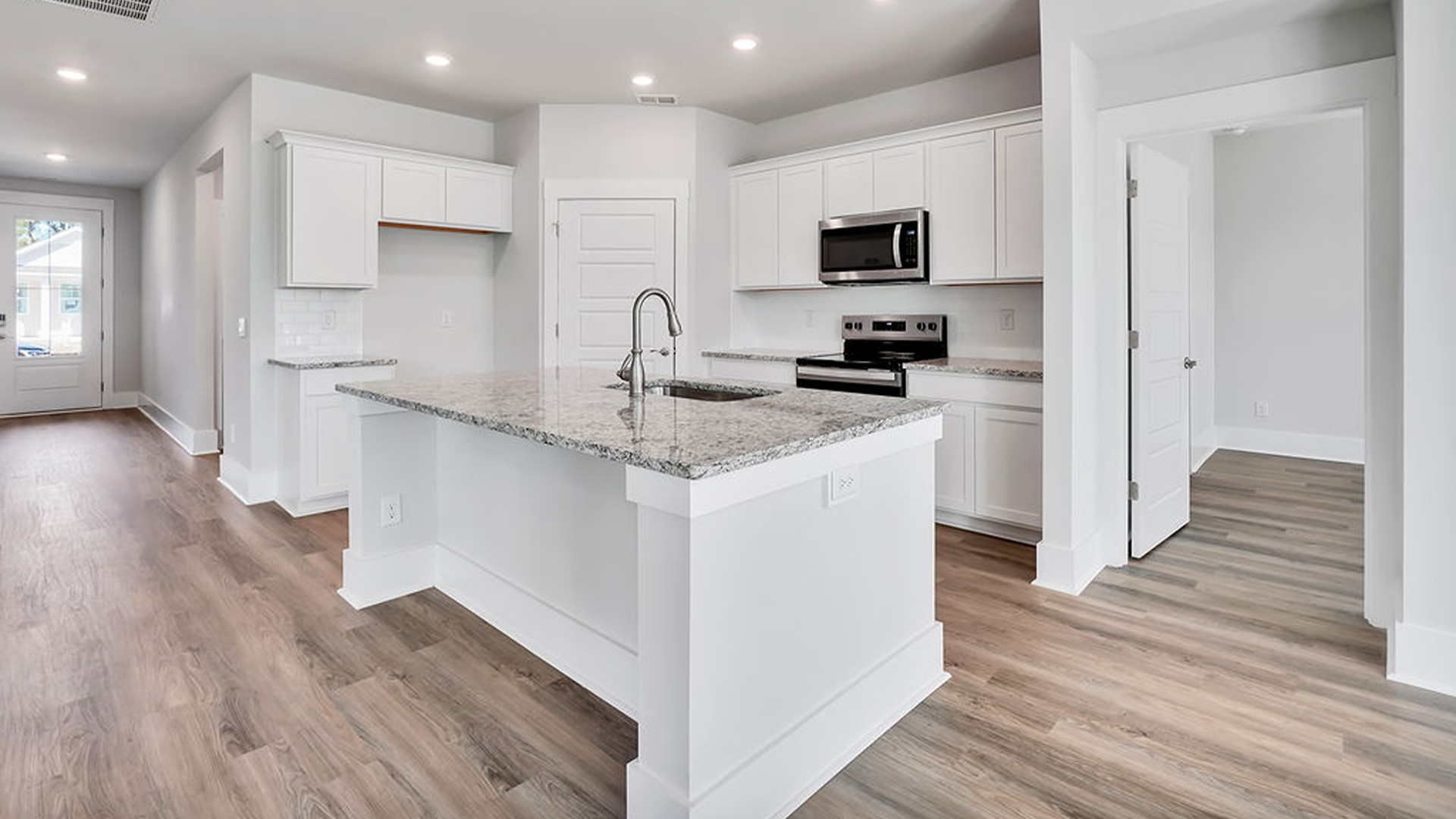 The Bradford is a versatile plan with an open concept kitchen, living, and dining area! The kitchen comes finished with beautiful granite countertops, stainless steel appliances, single-bowl sink and tile backsplash