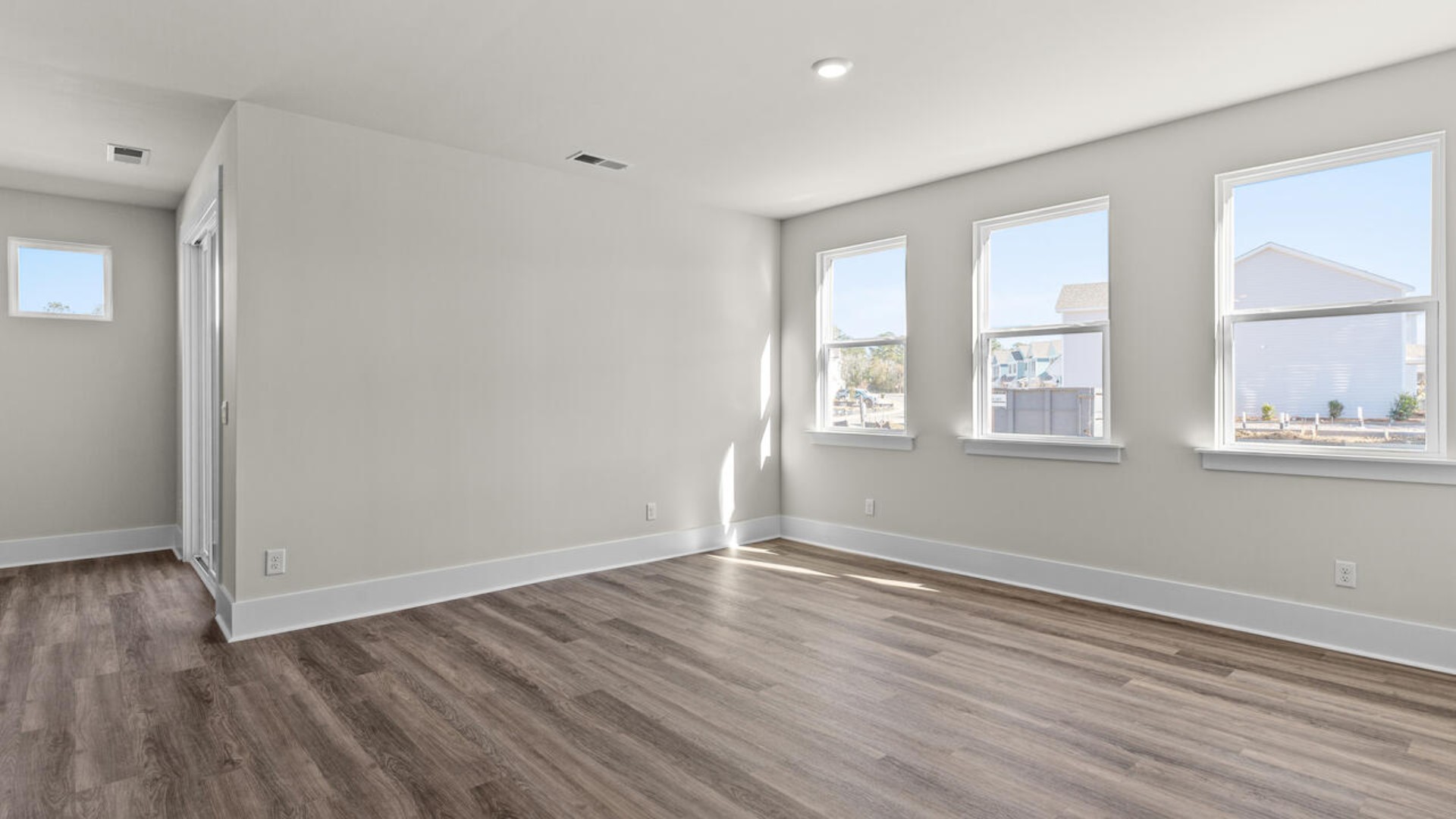 A large primary suite with bath that features separate sinks, granite countertops and a large walk-in closet.