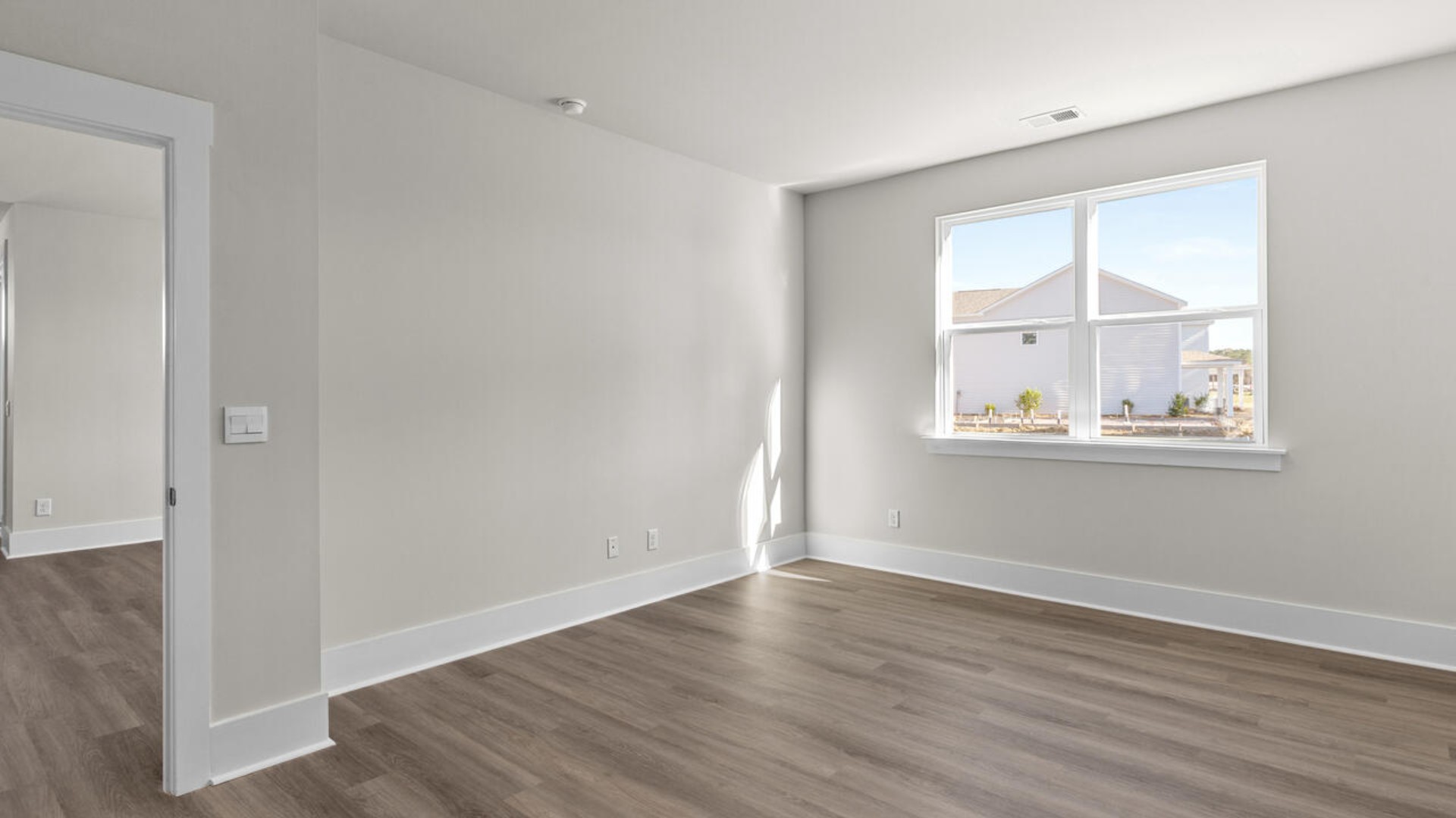 A large primary suite with bath that features separate sinks, granite countertops and a large walk-in closet.
