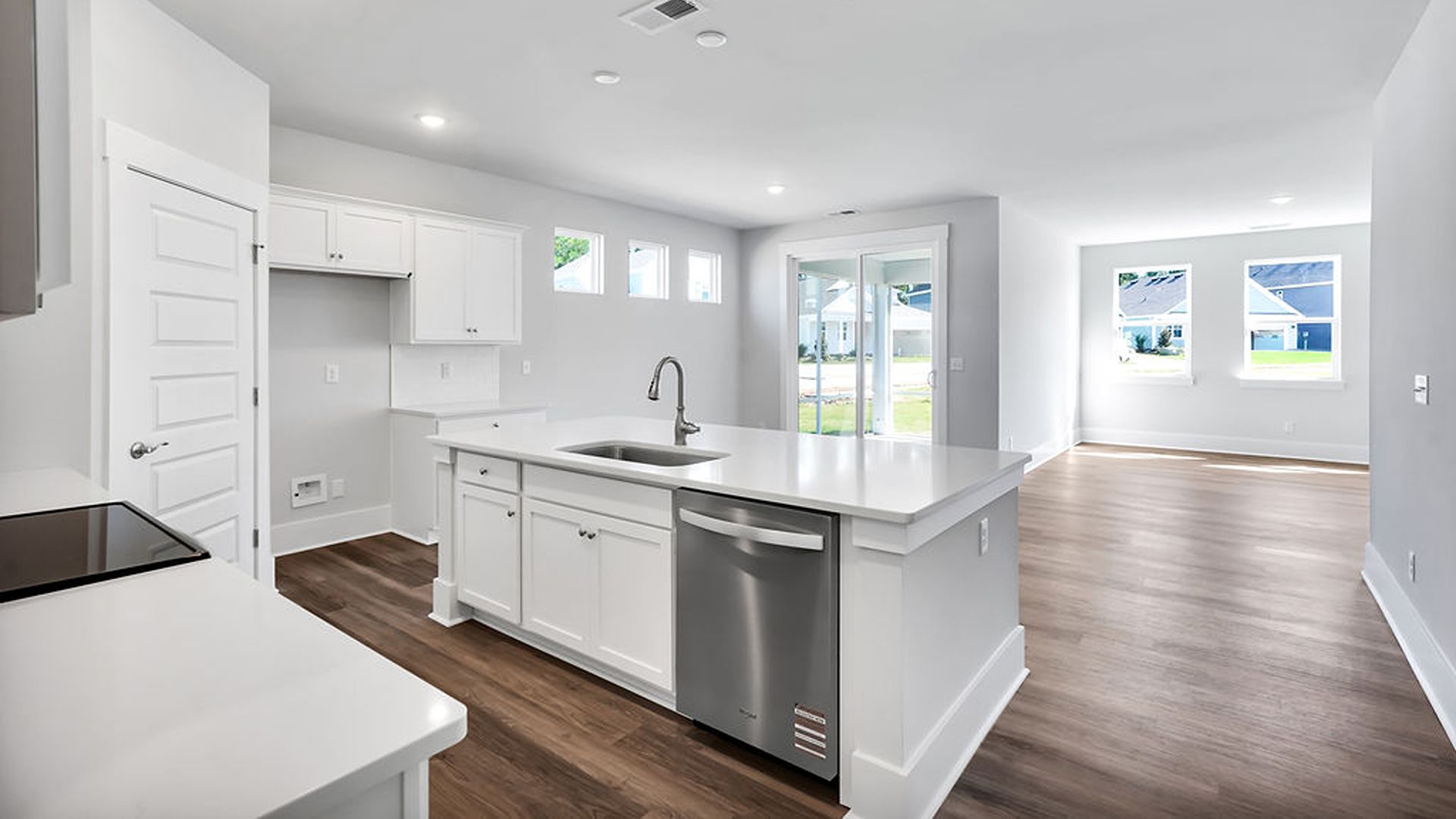 The kitchen features shaker-style cabinets, quartz countertops, and stainless-steel appliances, tile backsplash which are sure to both turn heads and make meal prep easy. You’ll never be too far from the action with the living and dining area right there.