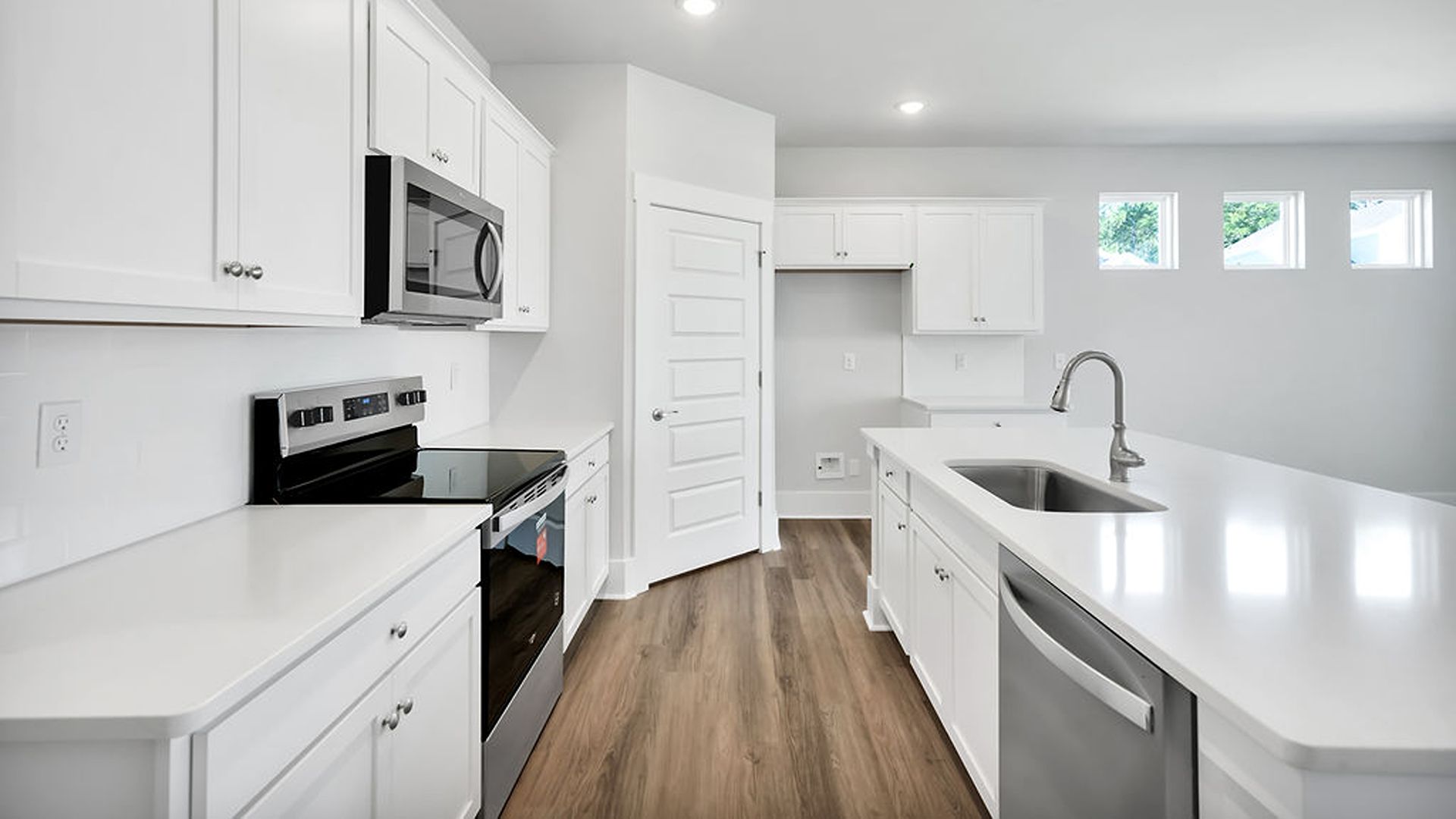 The kitchen features shaker-style cabinets, quartz countertops, and stainless-steel appliances, tile backsplash which are sure to both turn heads and make meal prep easy. You’ll never be too far from the action with the living and dining area right there.