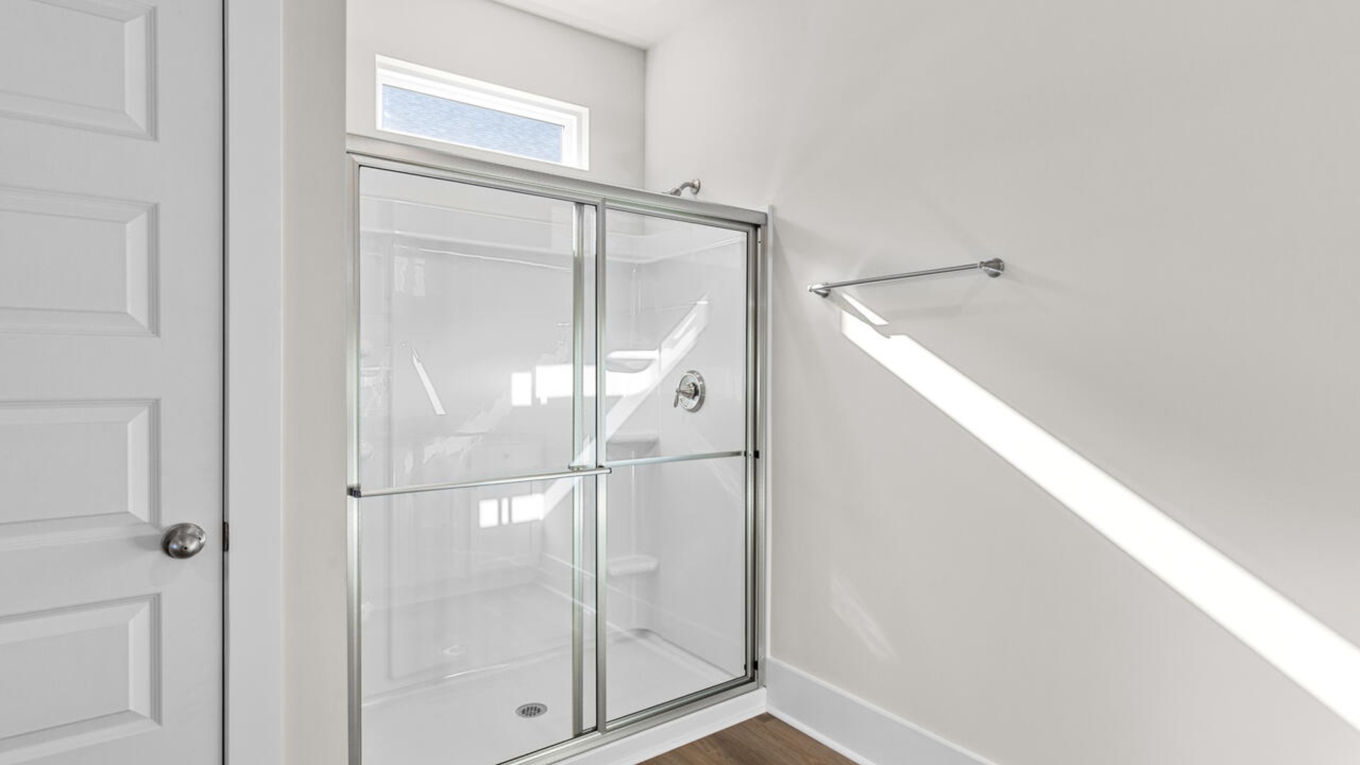 A large primary suite with bath that features separate sinks, granite countertops and a large walk-in closet.