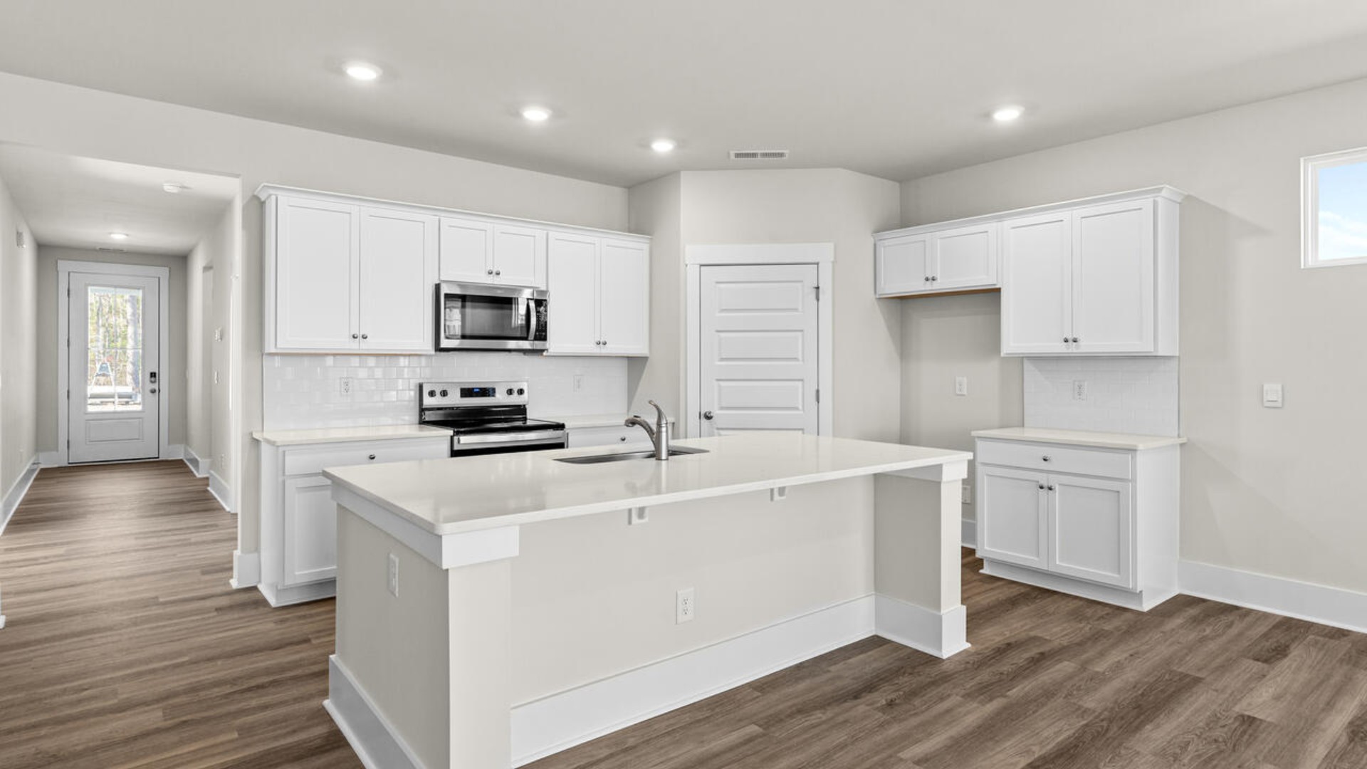The kitchen features shaker-style cabinets, quartz countertops, and stainless-steel appliances, tile backsplash which are sure to both turn heads and make meal prep easy. Y