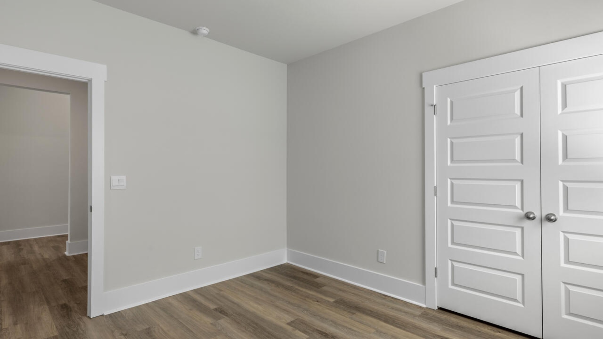 The split bedroom plan creates a private primary bedroom suite featuring two walk-in closets and a spacious en suite bath. There are three bedrooms at the front of the home with a full bathroom as well as laundry room.