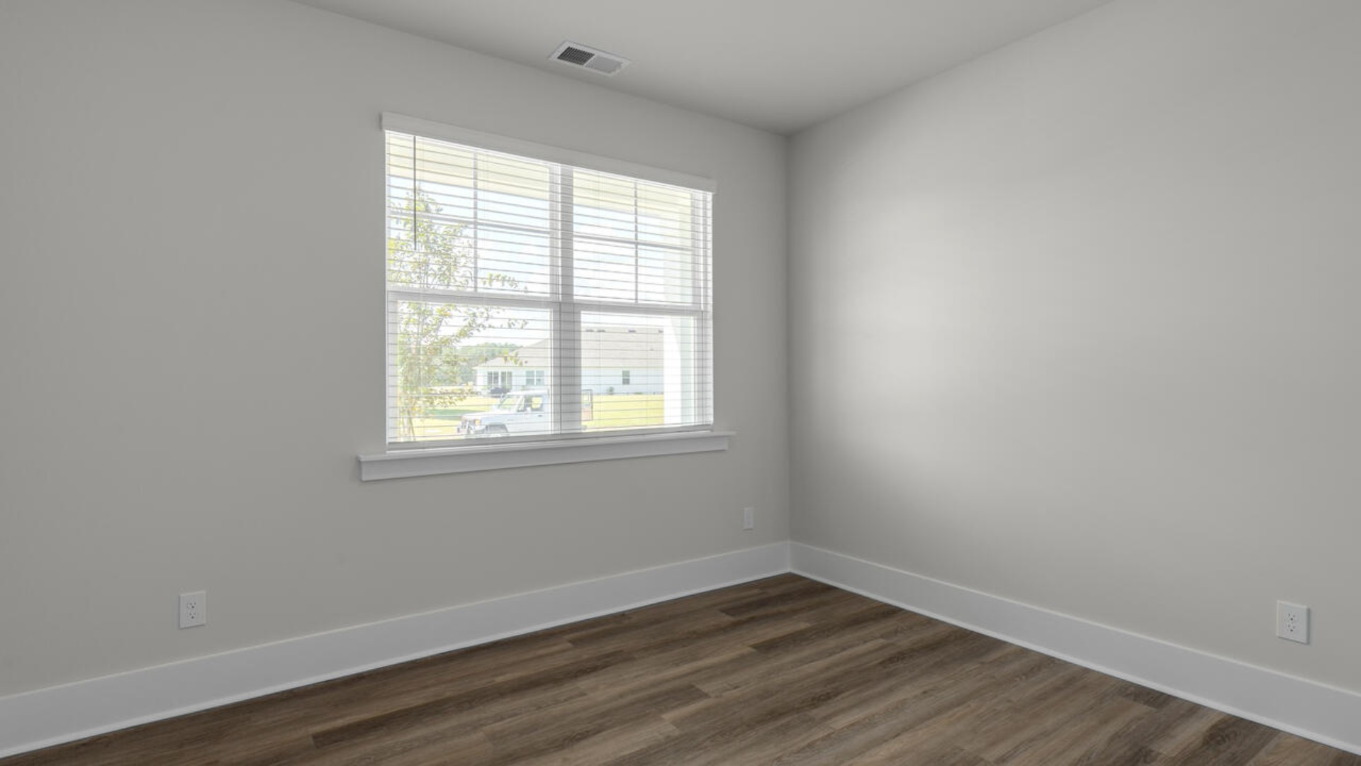 The split bedroom plan creates a private primary bedroom suite featuring two walk-in closets and a spacious en suite bath. There are three bedrooms at the front of the home with a full bathroom as well as laundry room.